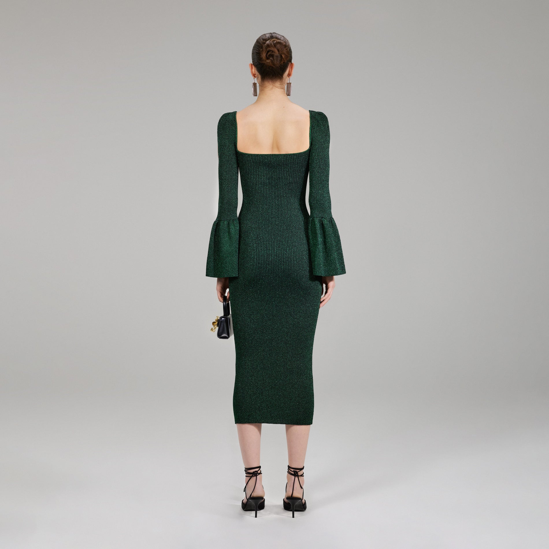 A woman wearing the Green Lurex Knit Midi Dress