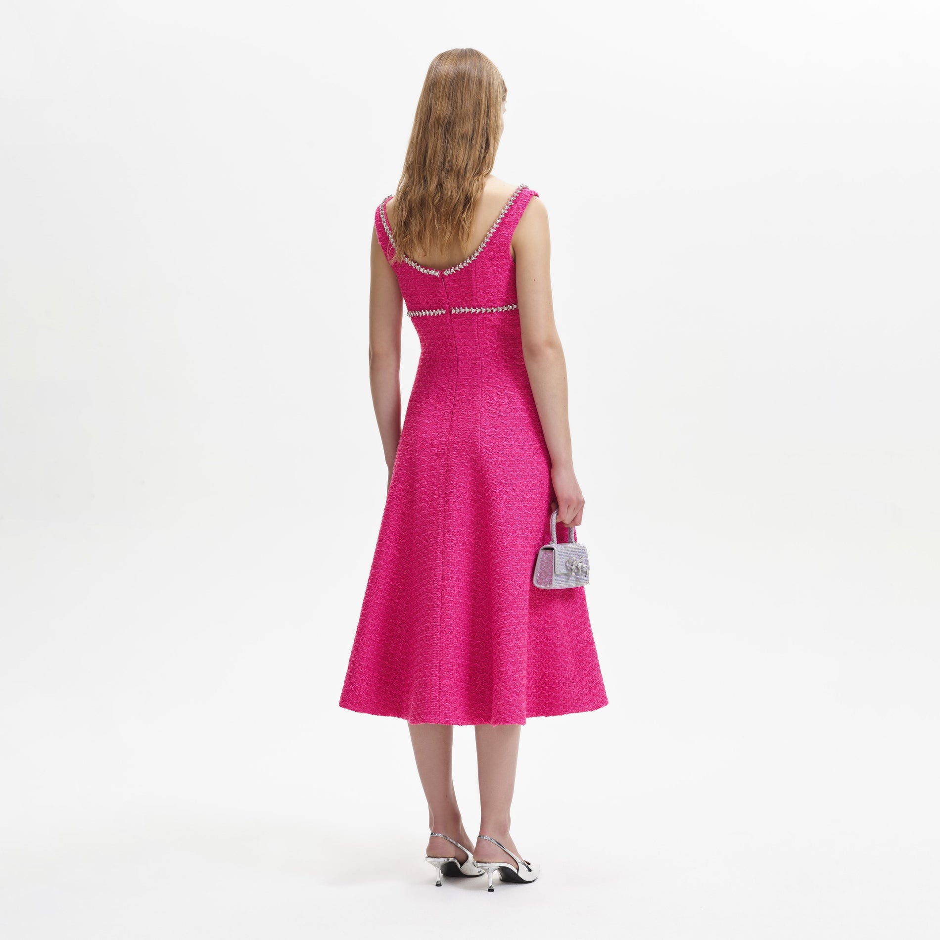 A woman wearing the Fuchsia Boucle Midi Dress