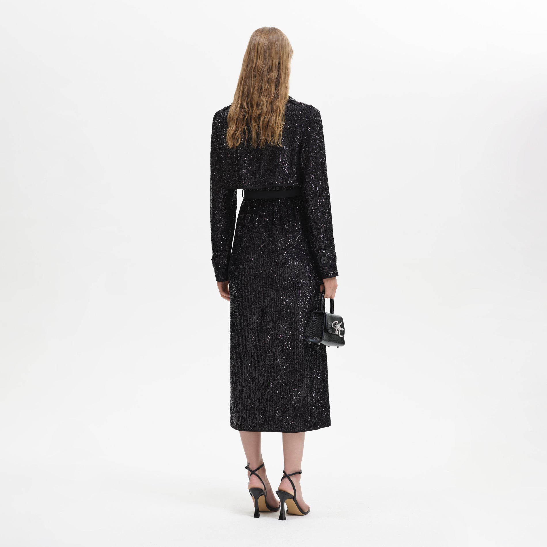 Back view of a woman wearing the Black Sequin Trench Coat