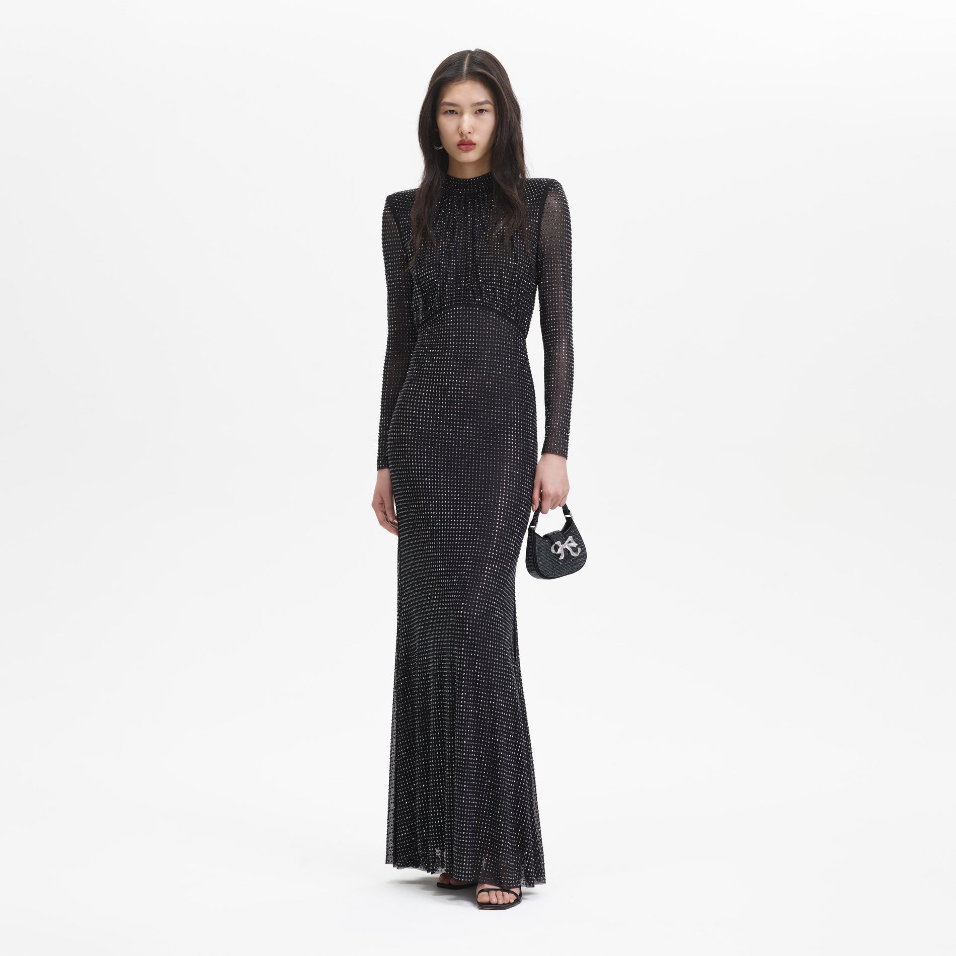 A woman wearing the Black Rhinestone Mesh Long Sleeve Maxi Dress