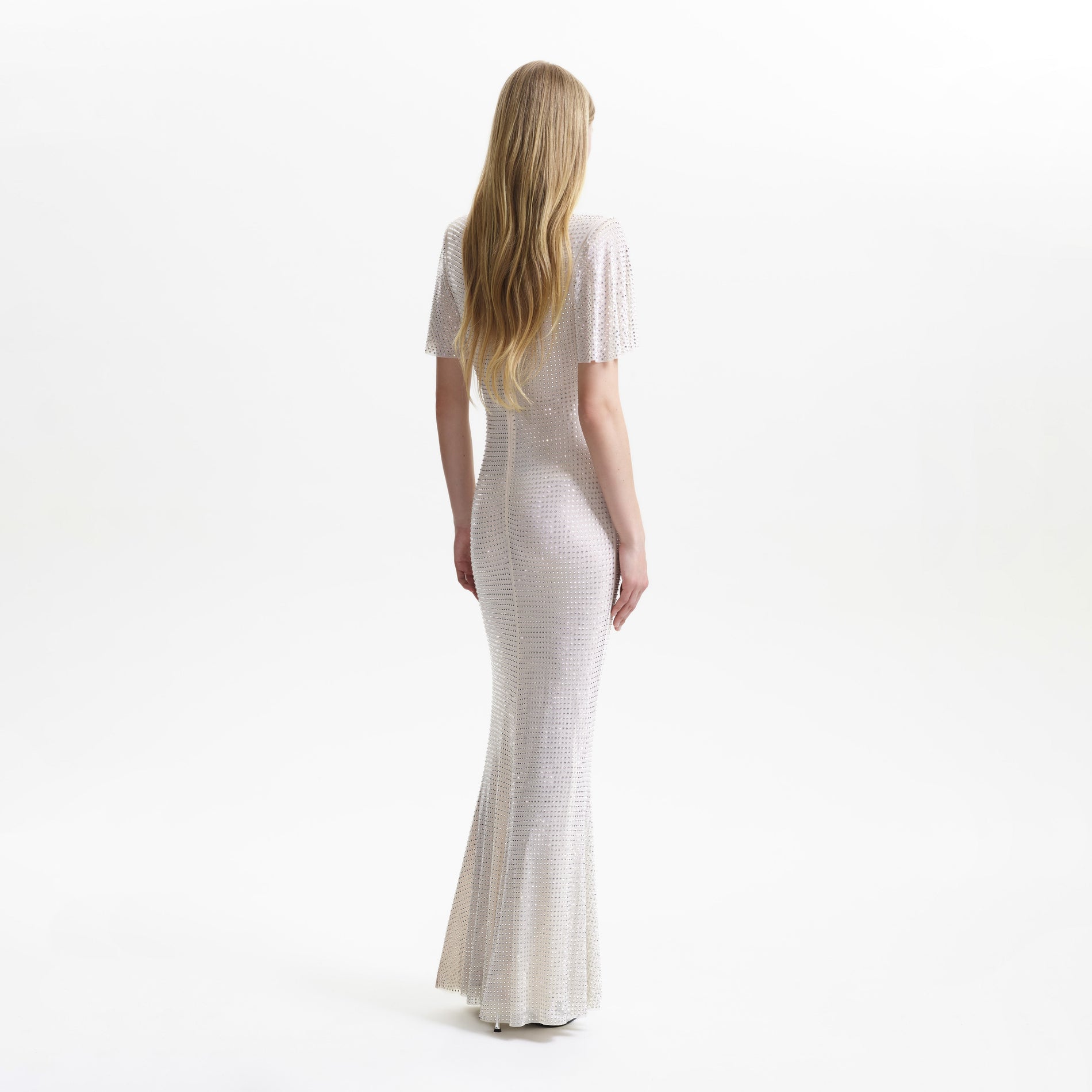 A woman wearing the Cream Rhinestone Mesh Maxi Dress