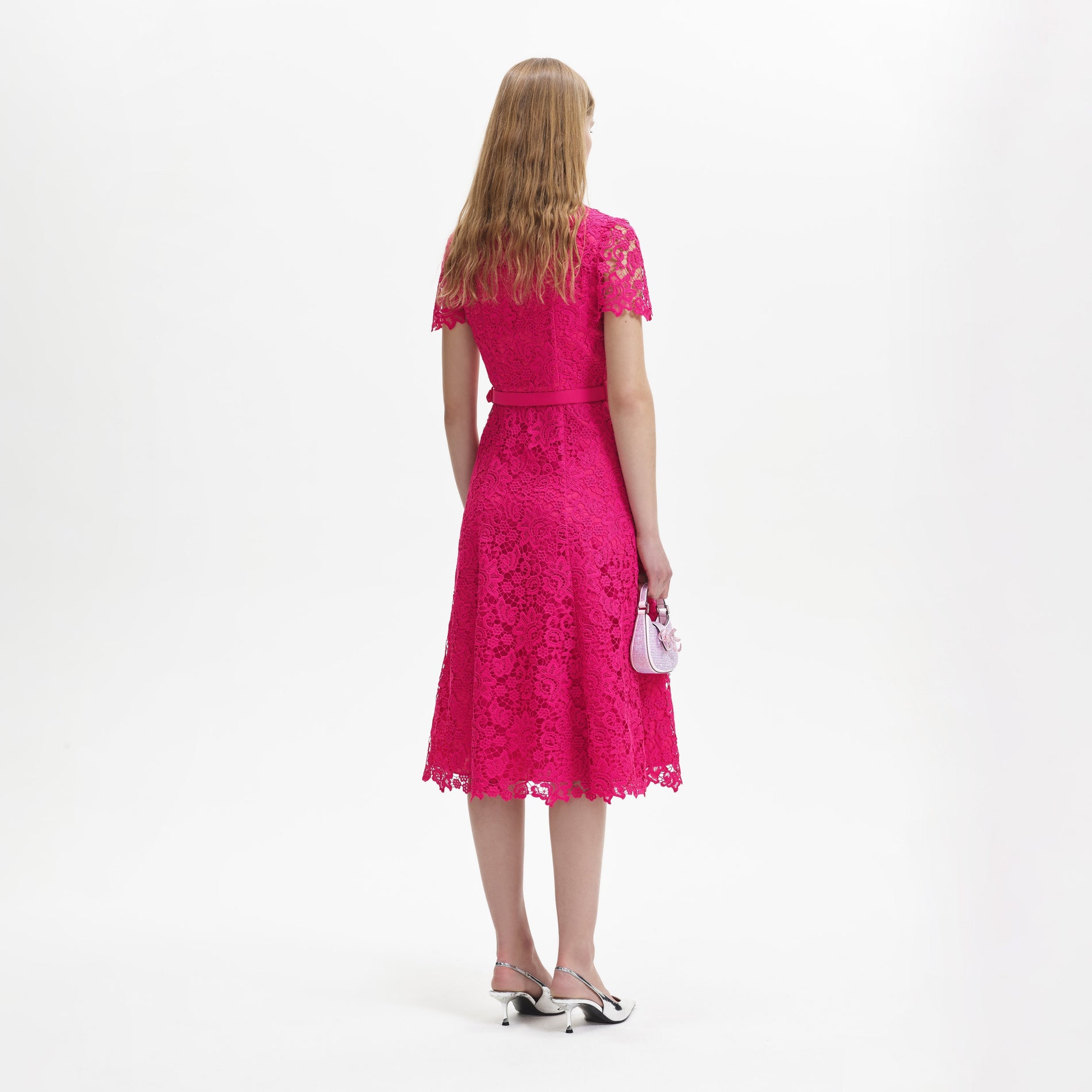 A woman wearing the Magenta Lace Midi Dress