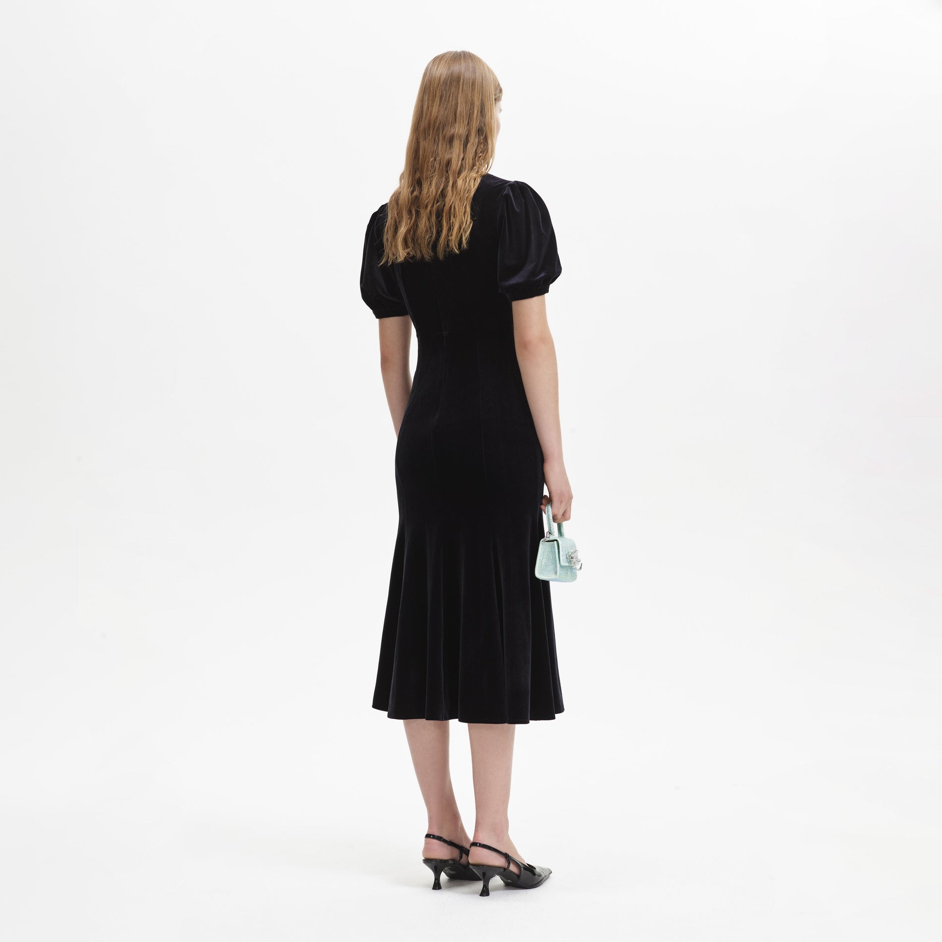 Back view of a woman wearing the Black Velvet Embellished Midi Dress