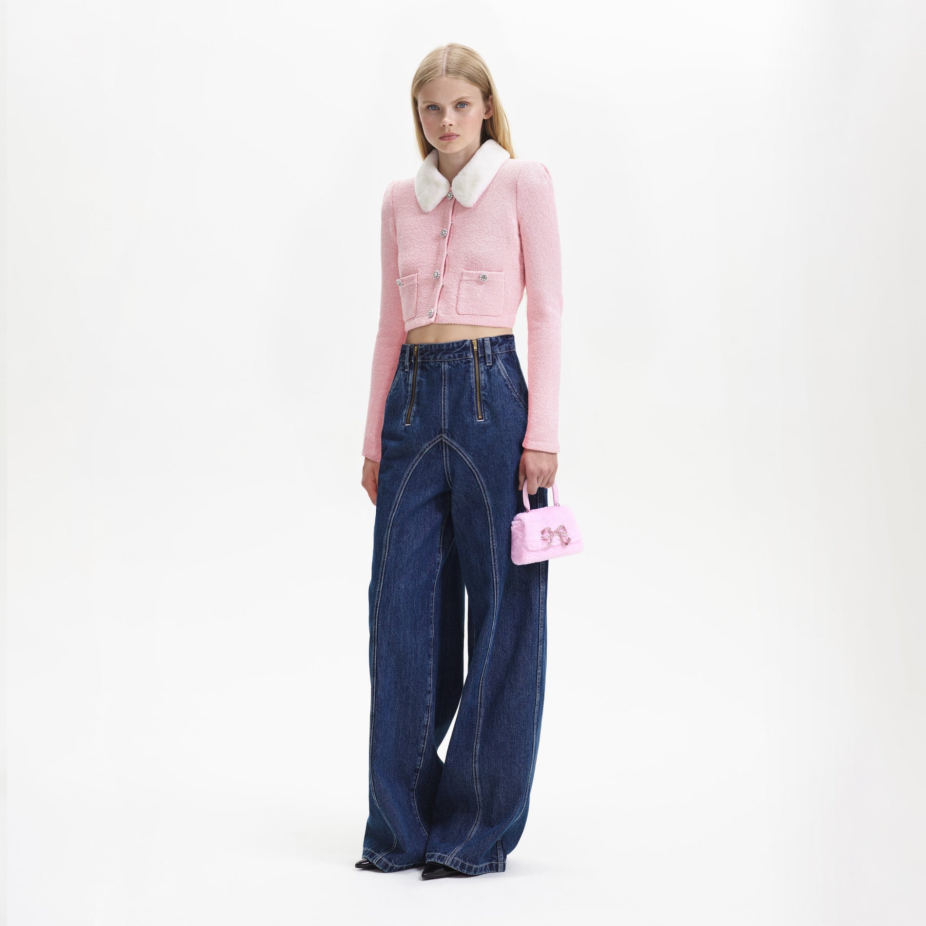 Side view of a woman wearing the Pink Faux Fur Collar Cardigan