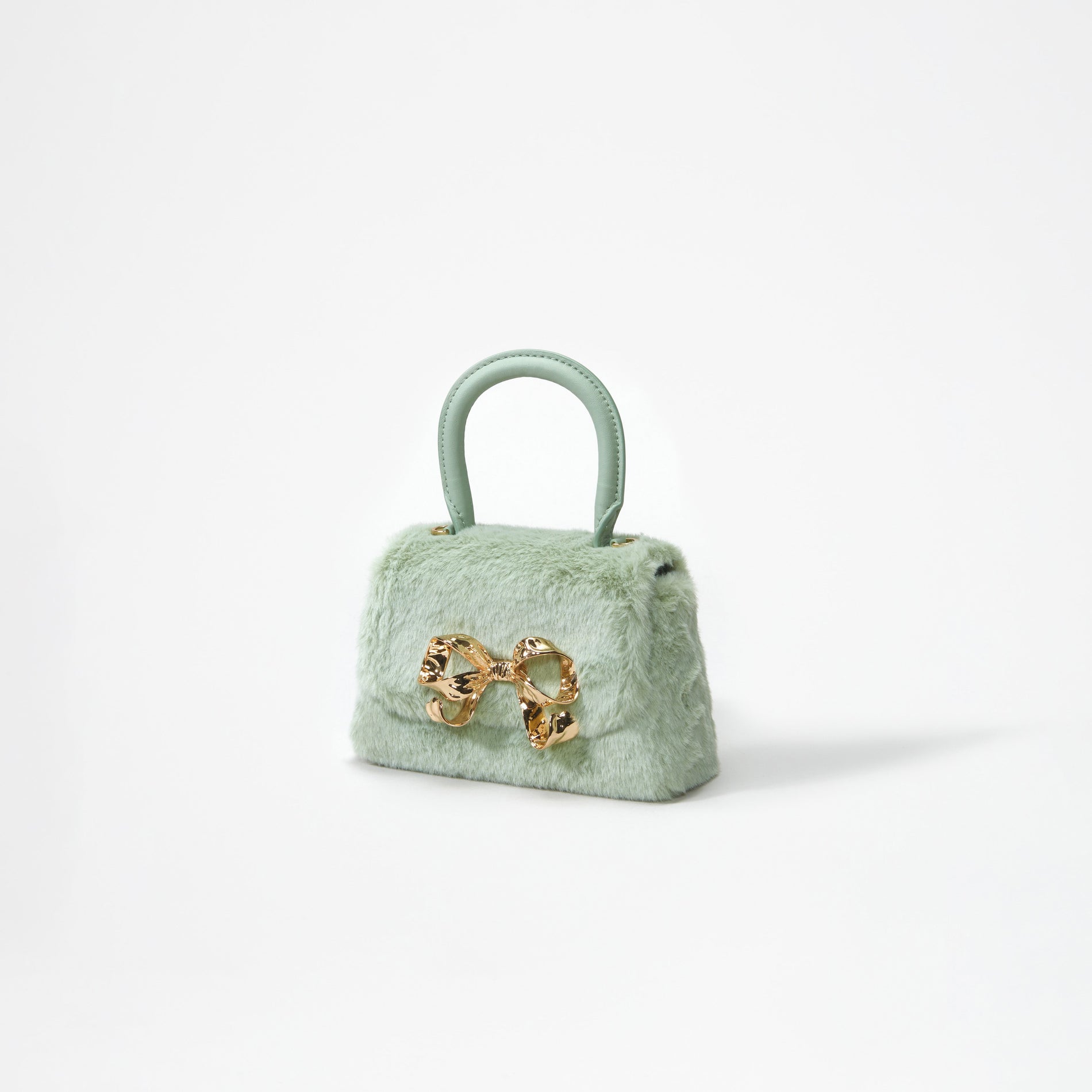 A woman wearing the Green Fluffy Bow Micro Bag