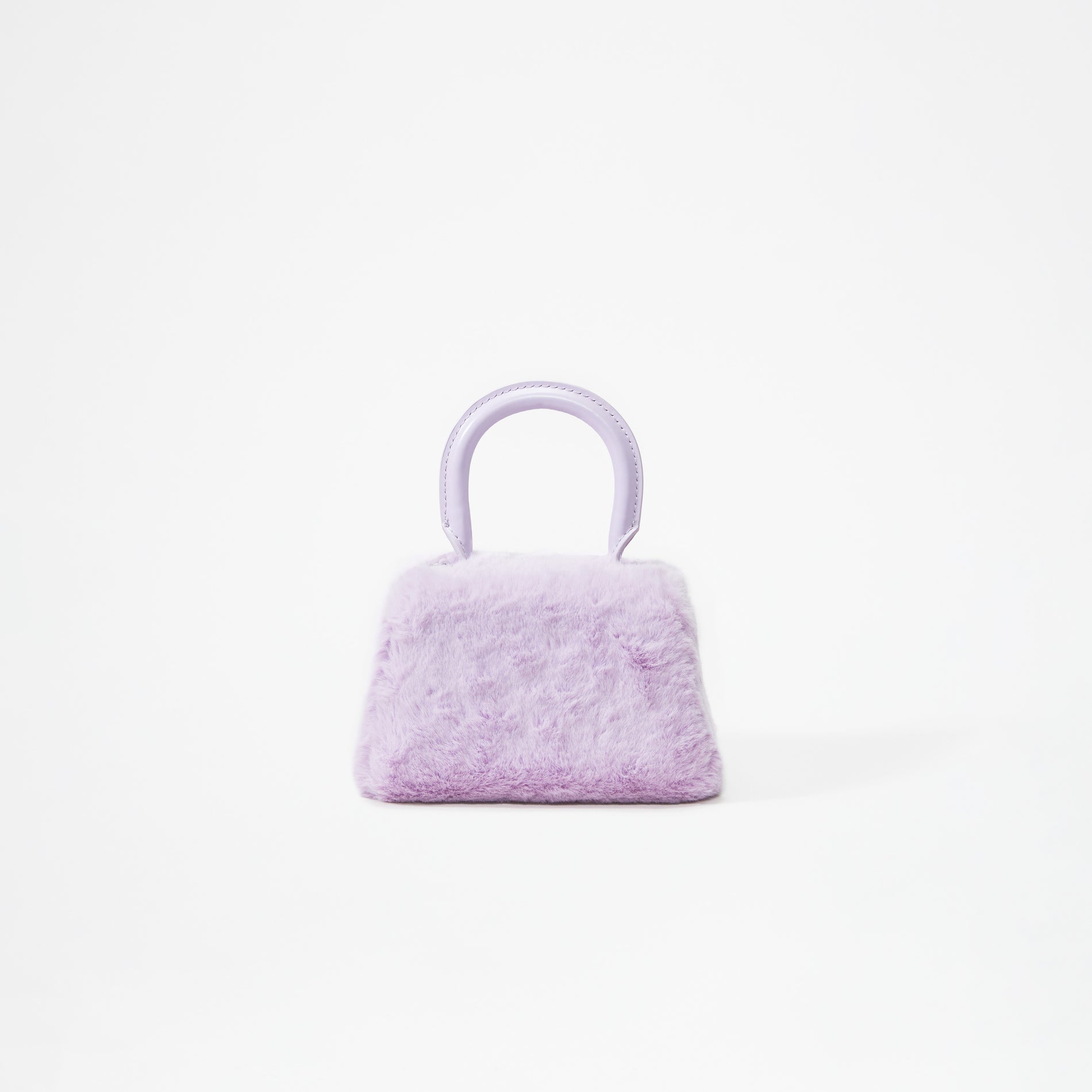 A woman wearing the Lilac Fluffy Bow Micro Bag
