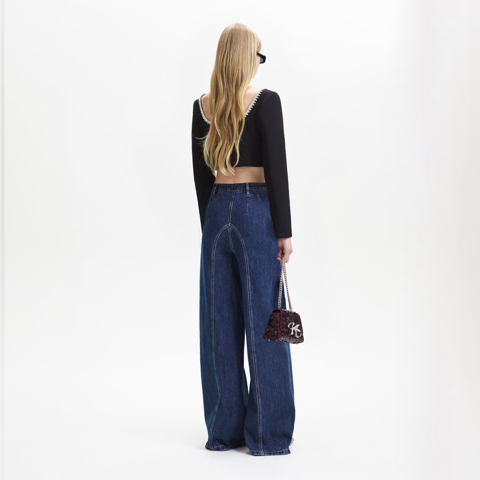 A woman wearing the Blue Wide Leg Stitch Detail Jeans