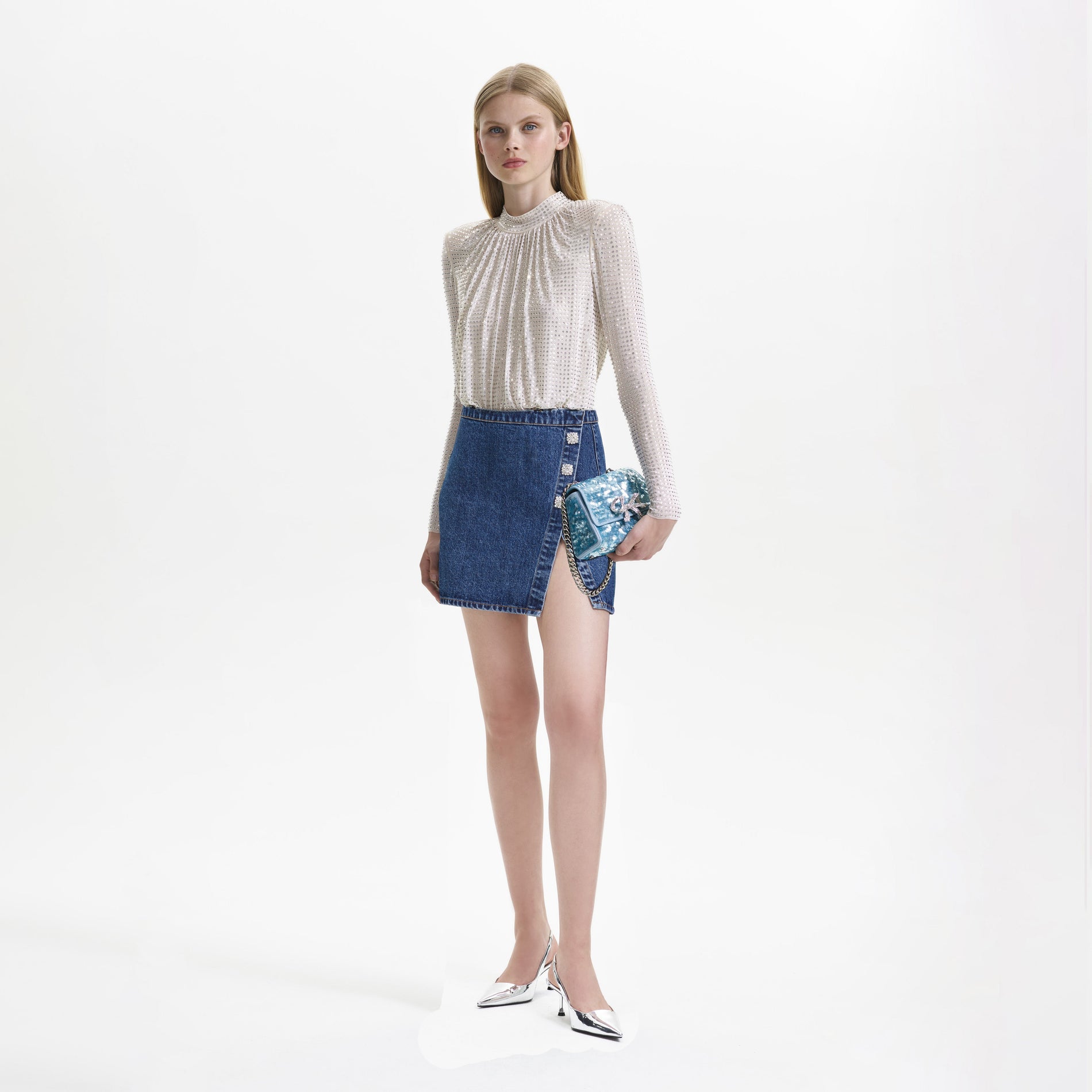Side view of a woman wearing the Denim Mini Skirt