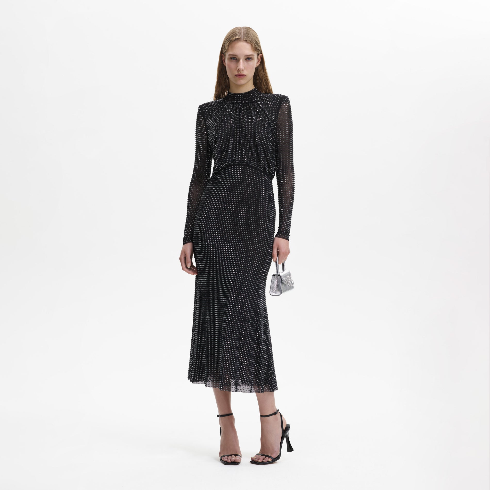 A woman wearing the Black Rhinestone Mesh Long Sleeve Midi Dress