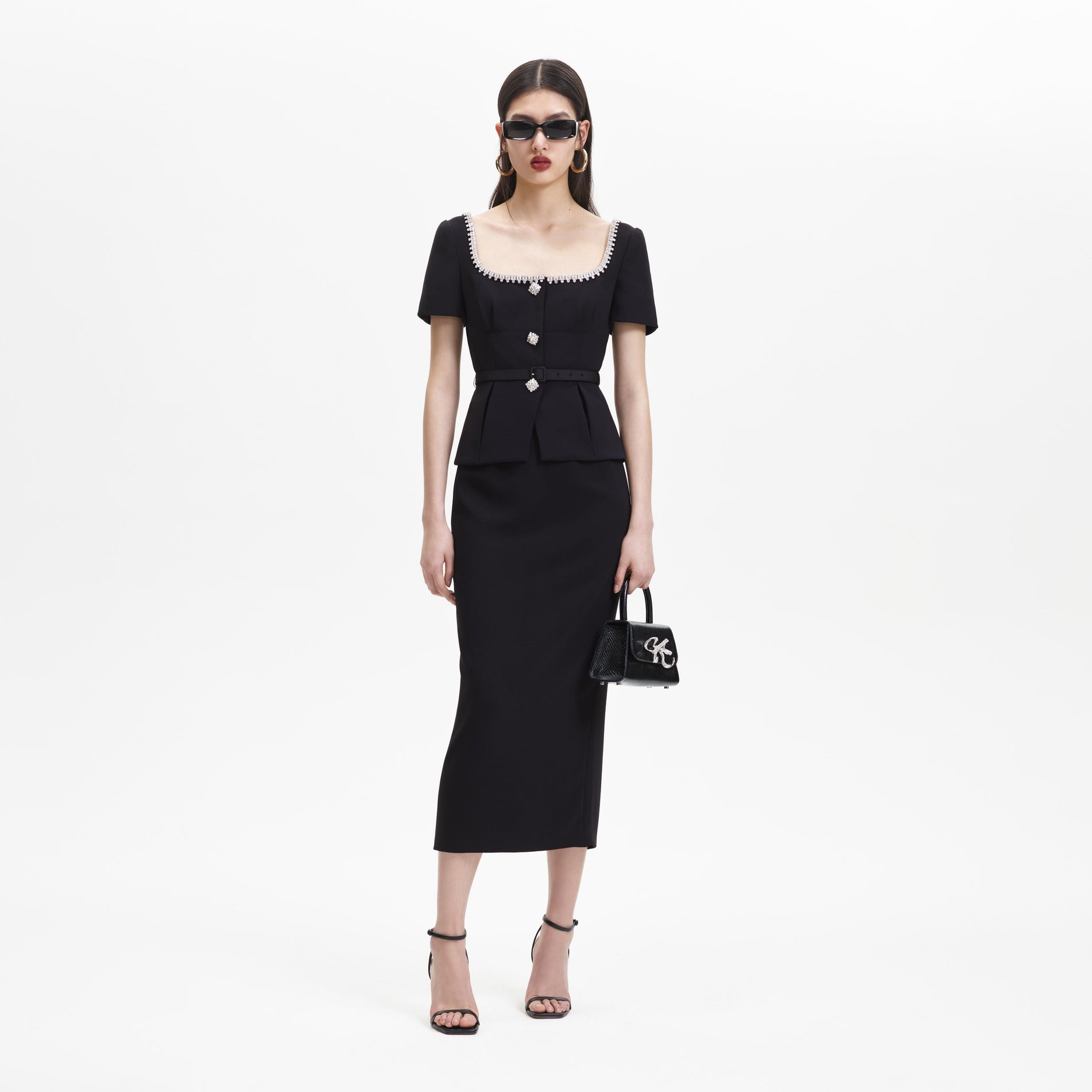 A woman wearing the Black Bonded Crepe Midi Dress