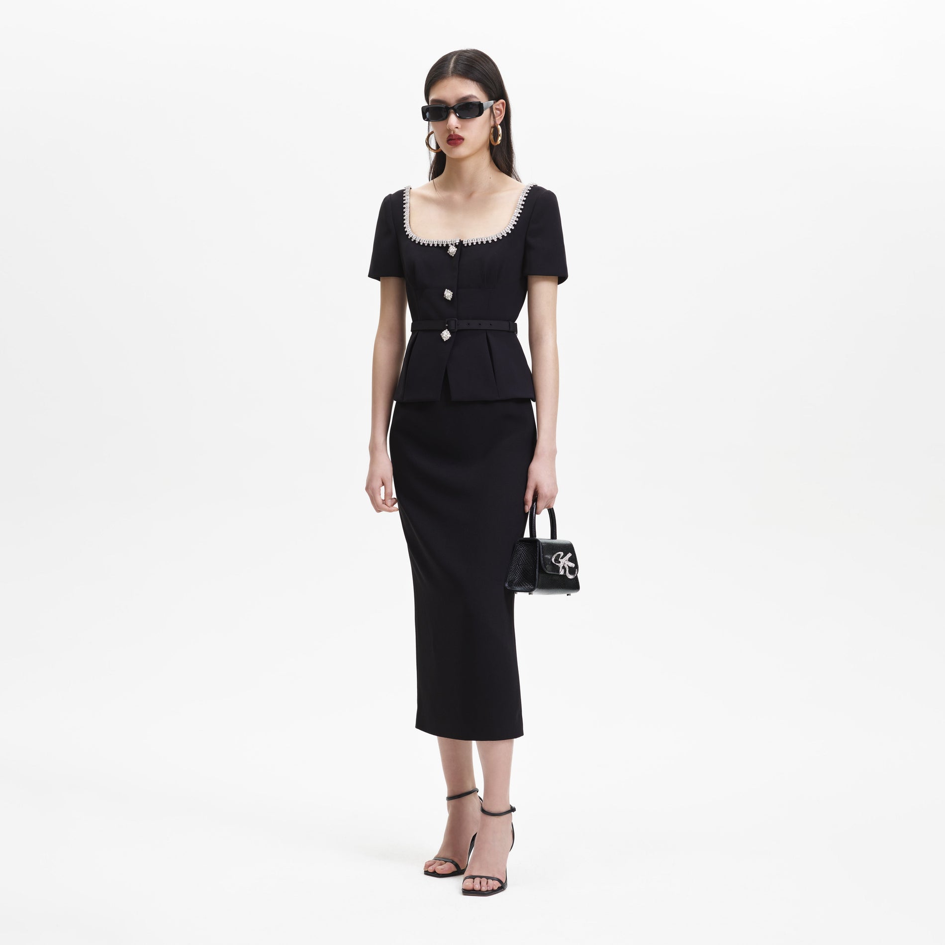 A woman wearing the Black Bonded Crepe Midi Dress