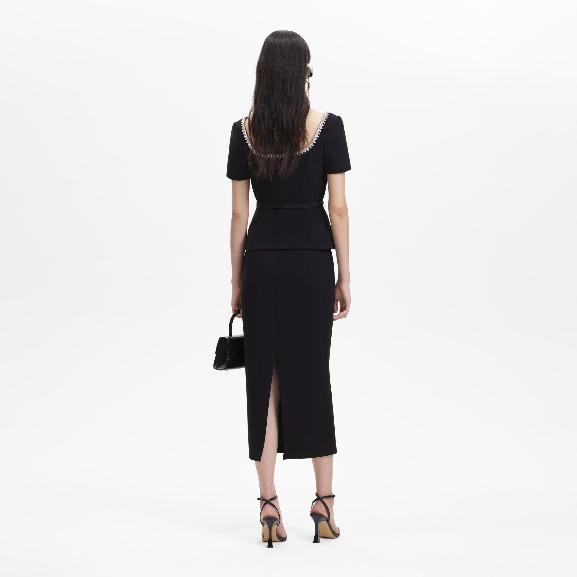 A woman wearing the Black Bonded Crepe Midi Dress