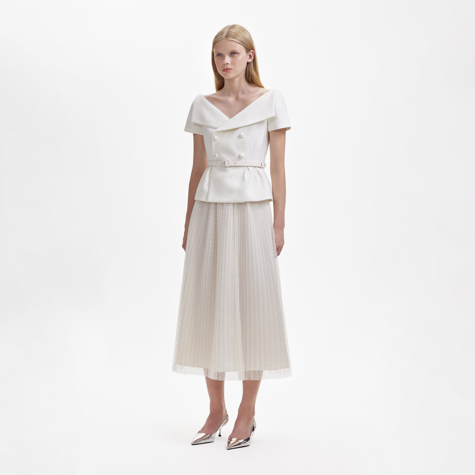 A woman wearing the Cream Off Shoulder Midi Dress