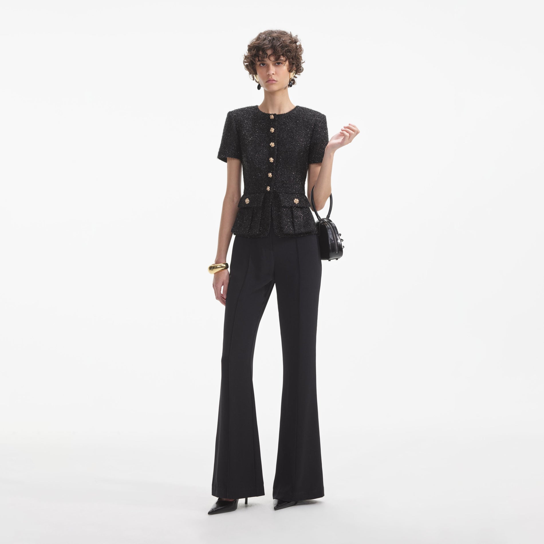 Side view of a woman wearing the Black Tinsel Boucle Jumpsuit