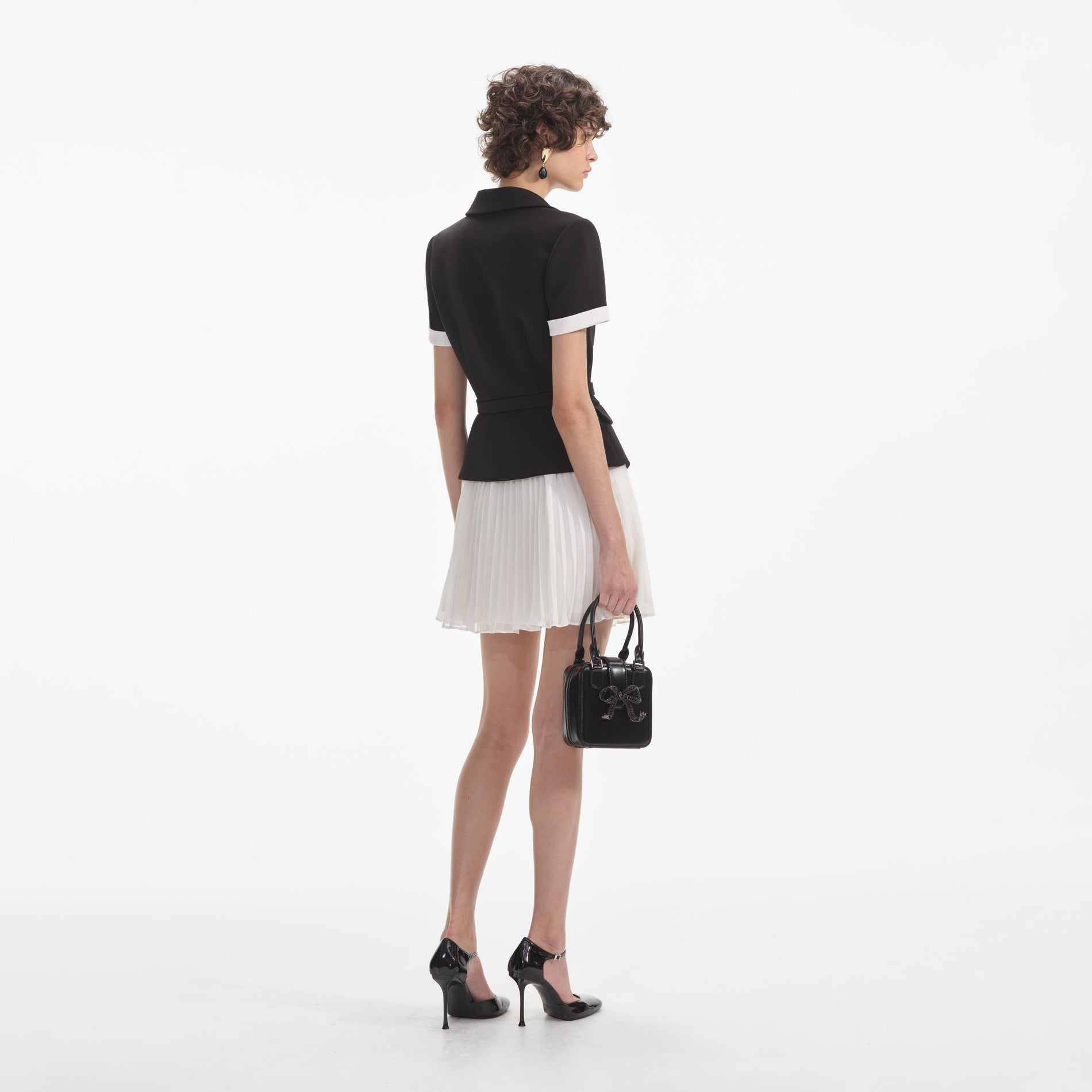 Back view of a woman wearing the White Black Crepe Contrast Chiffon Mini Dress