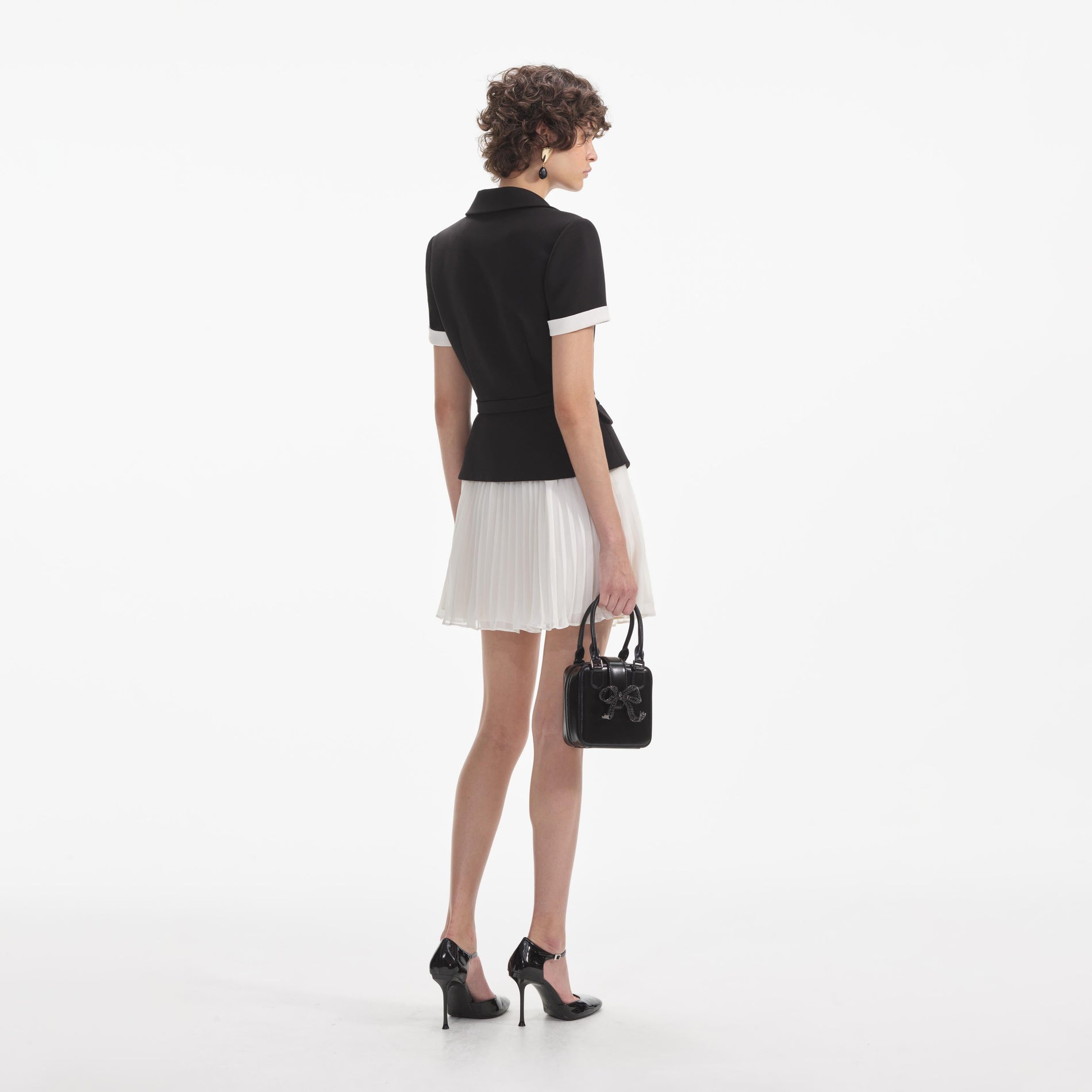 Back view of a woman wearing the Black Crepe Contrast Chiffon Mini Dress