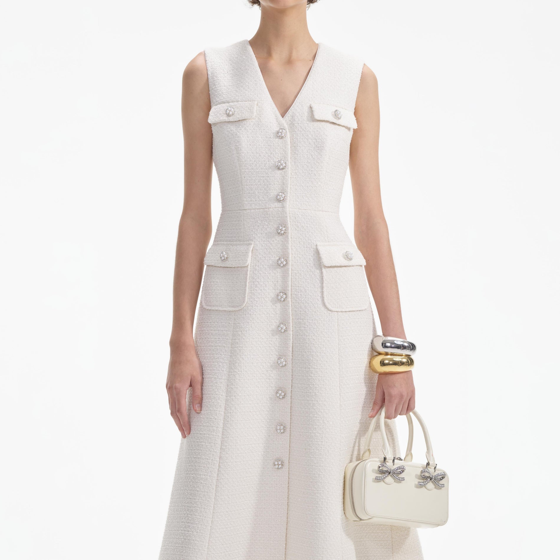 A close up of a woman wearing the Cream Tinsel Boucle Buttoned Midi Dress