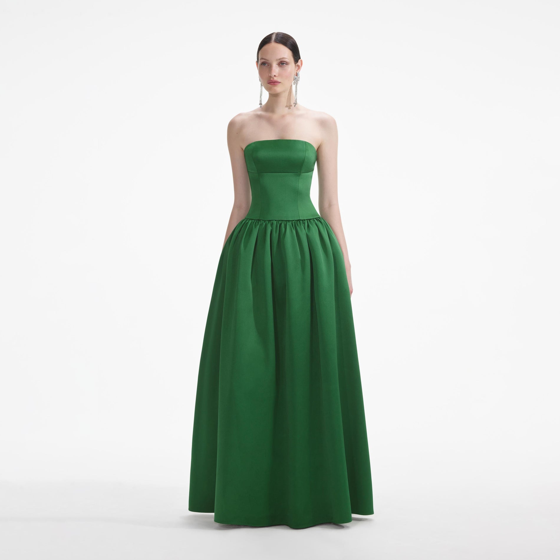 Side view of a woman wearing the Green Satin Bandeau Maxi Dress