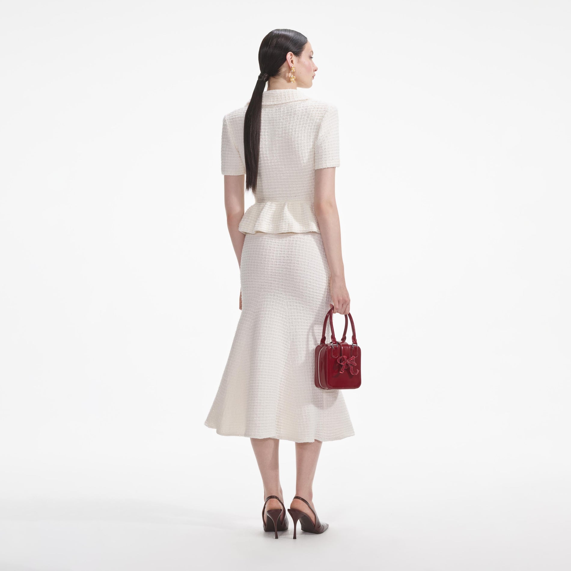 Back view of a woman wearing the White Cream Textured Knit Midi Dress