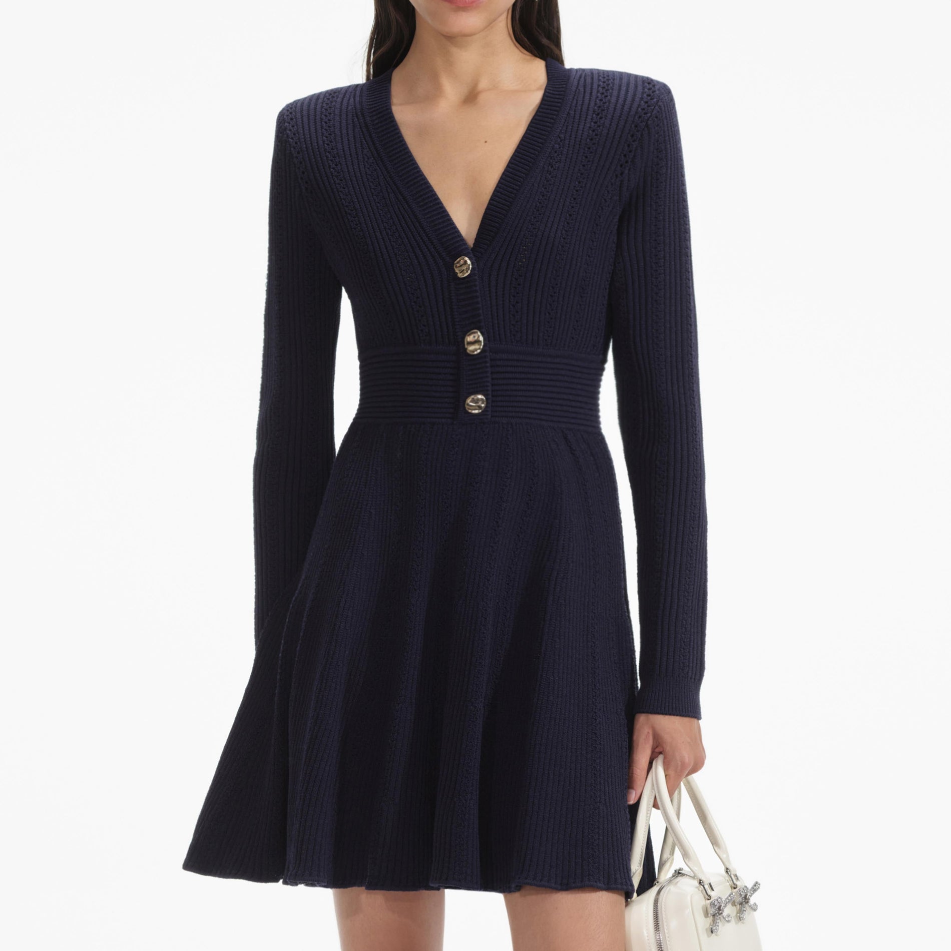 A close up of a woman wearing the Navy Pointelle Knit Mini Dress