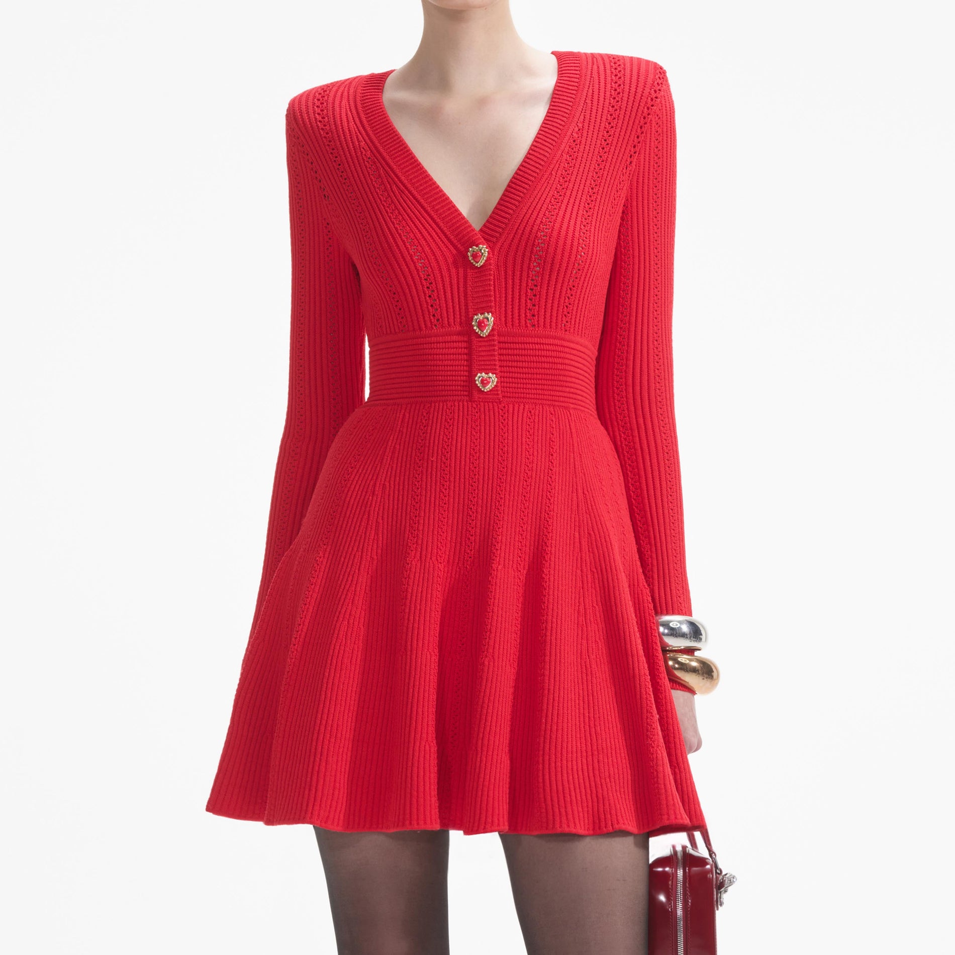 A close up of a woman wearing the Red Pointelle Knit Mini Dress