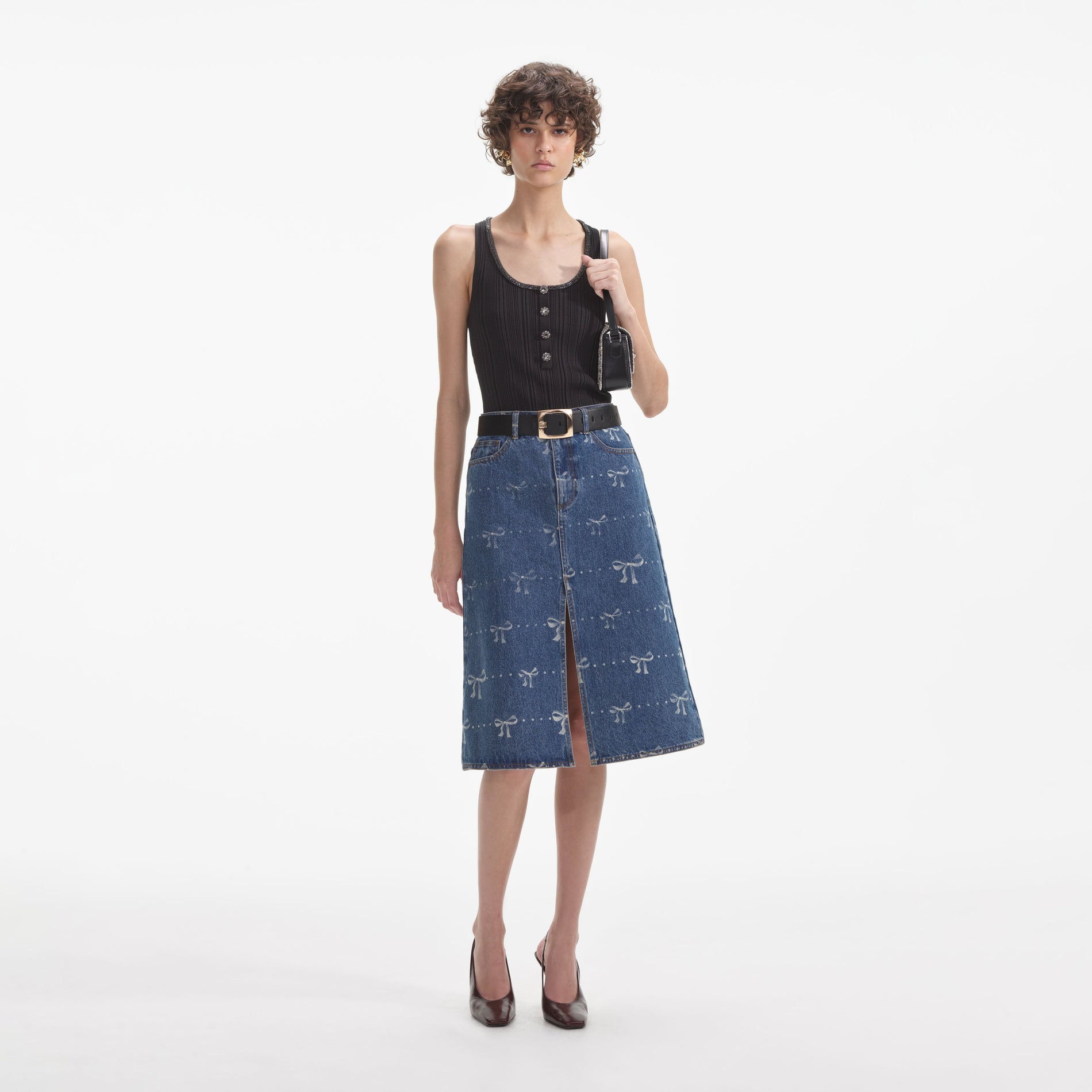 Front view of a woman wearing the Bow Print Denim Midi Skirt