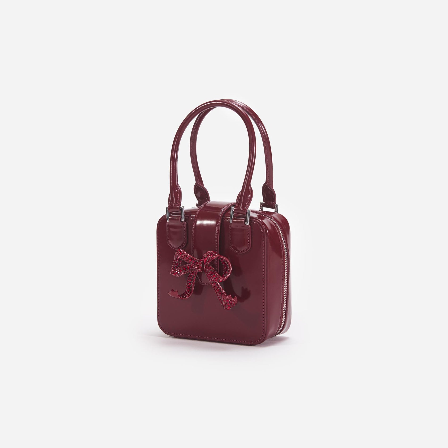 Side view of a woman wearing the Burgundy Leather Square Mini Tote Bag