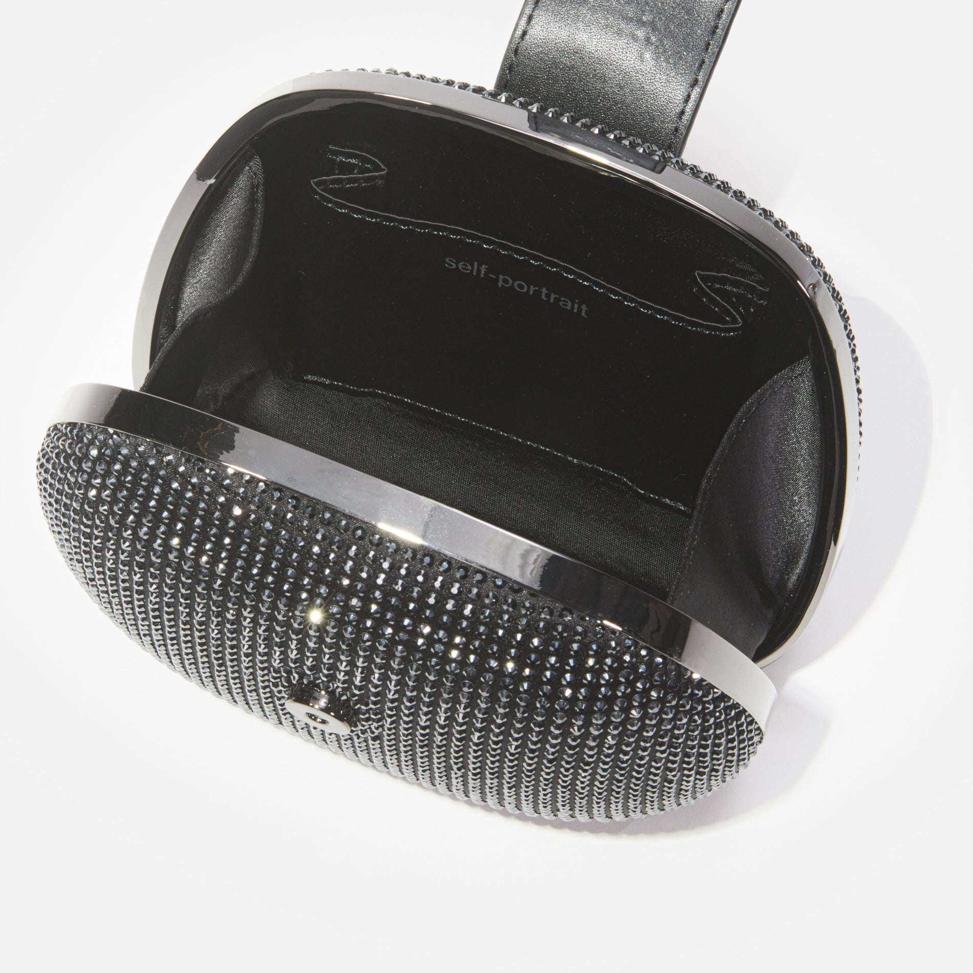 A close up of a woman wearing the Black Rhinestone Top Handle Clutch Bag