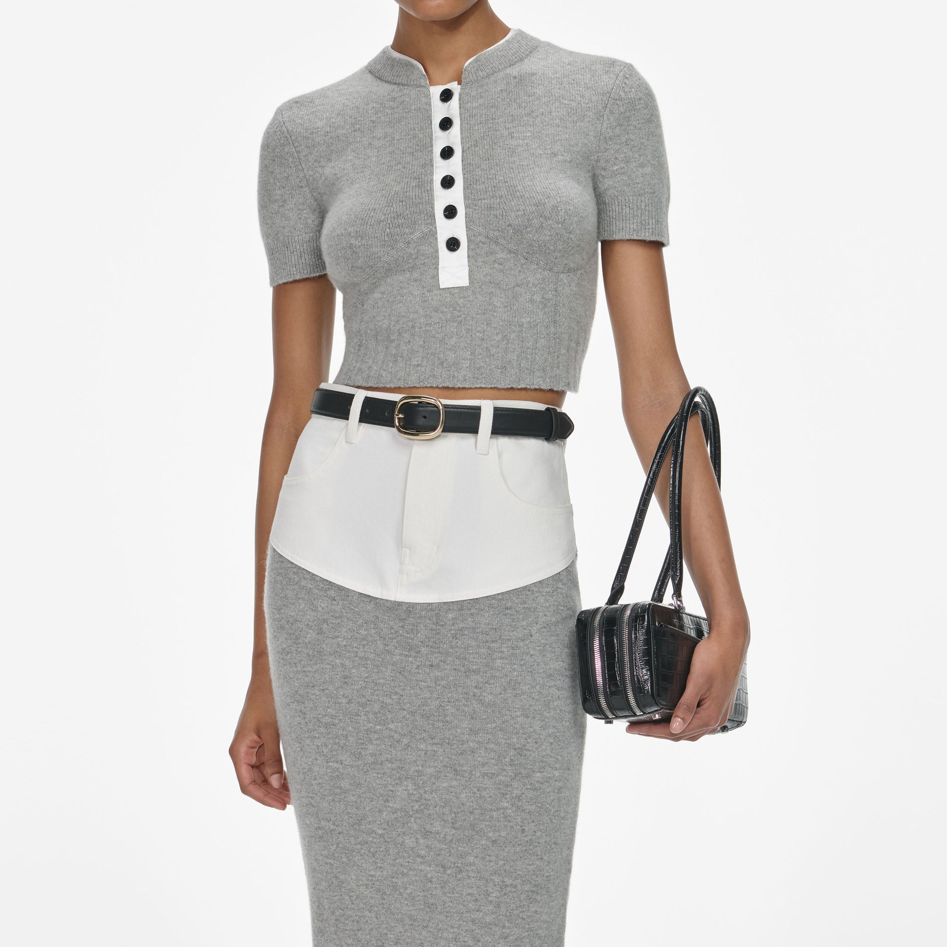 A close up of a woman wearing the Grey Knit Denim Insert Midi Skirt