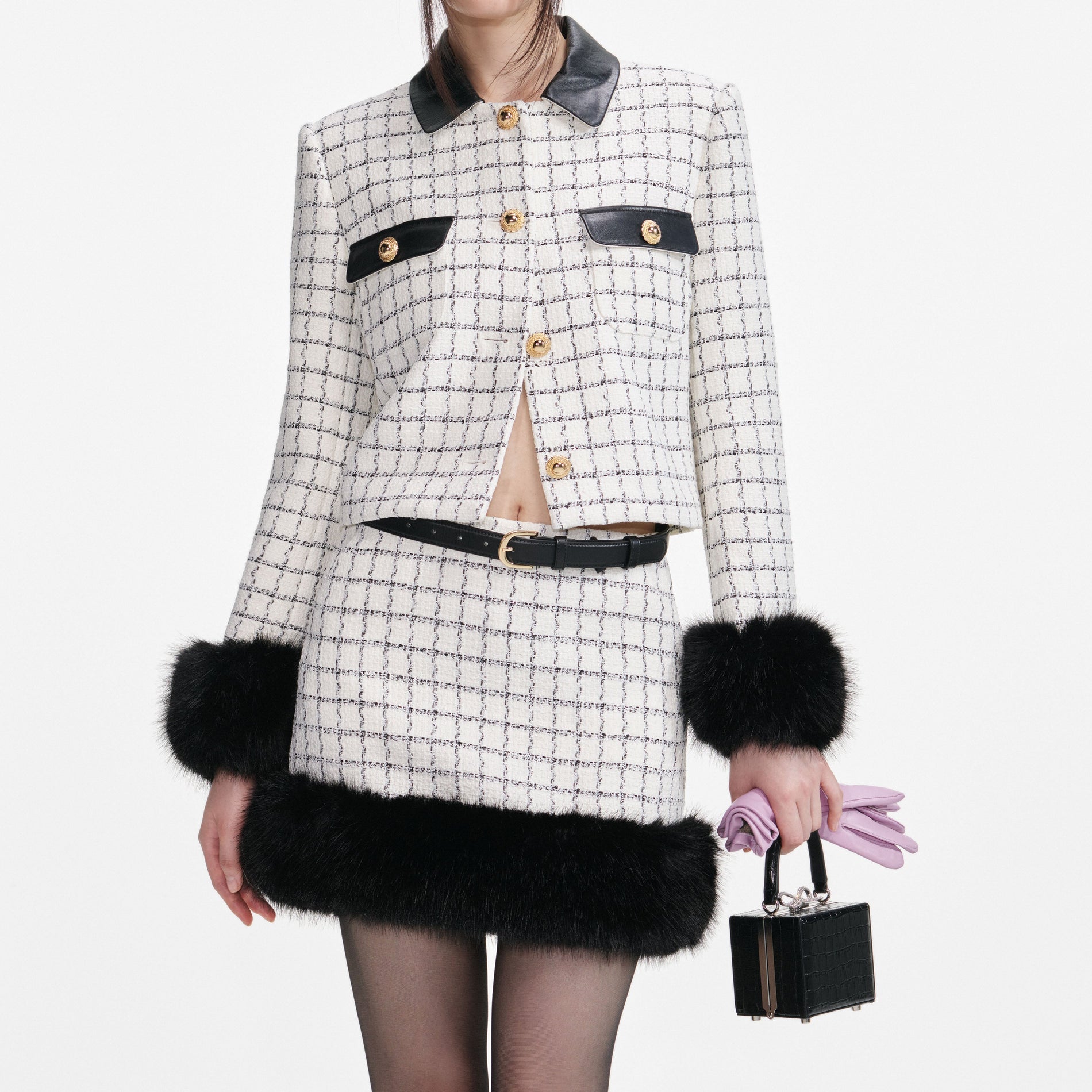 A close up of a woman wearing the Check Boucle Fur Hem Mini Skirt