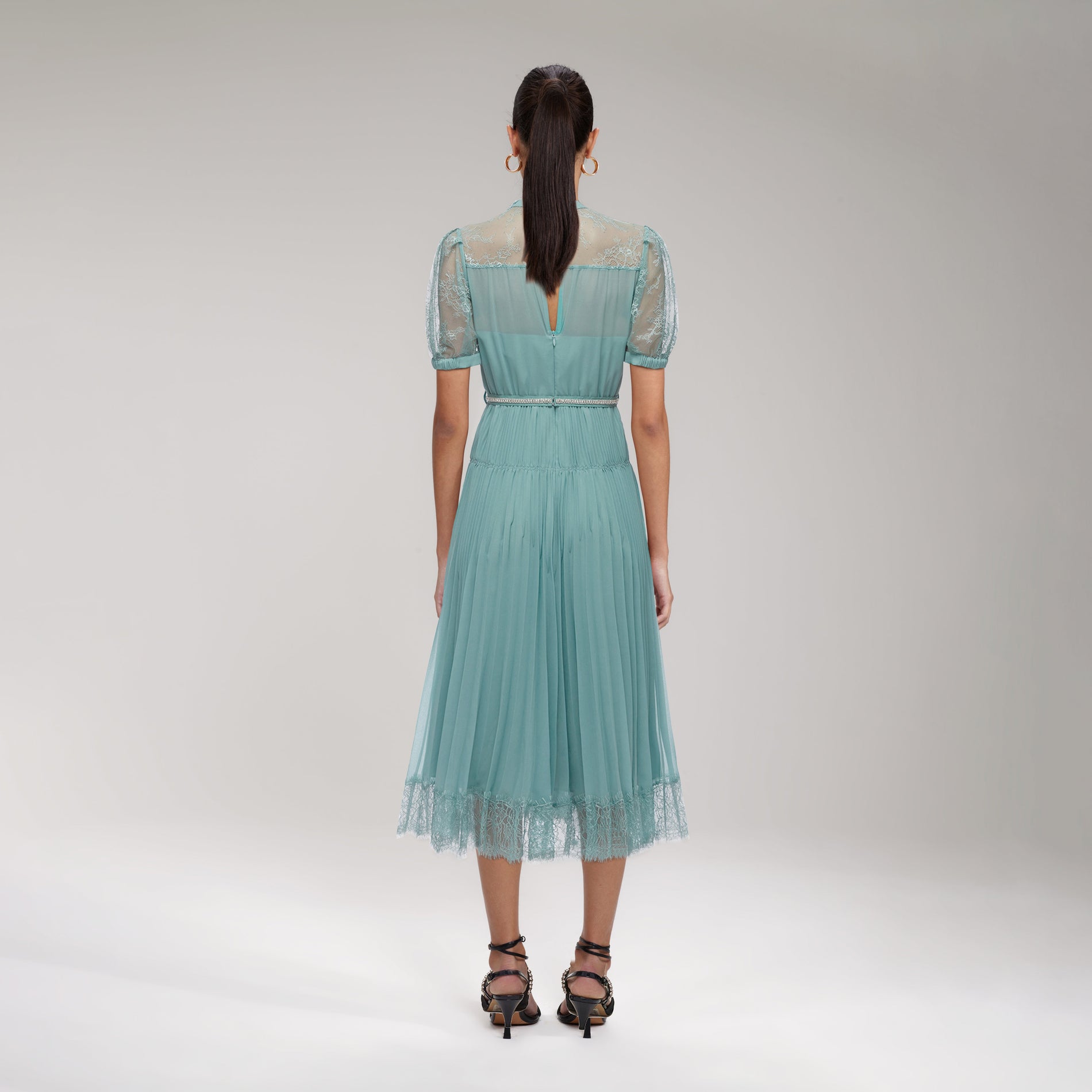 A woman wearing the Sage Lace Trim Midi Dress