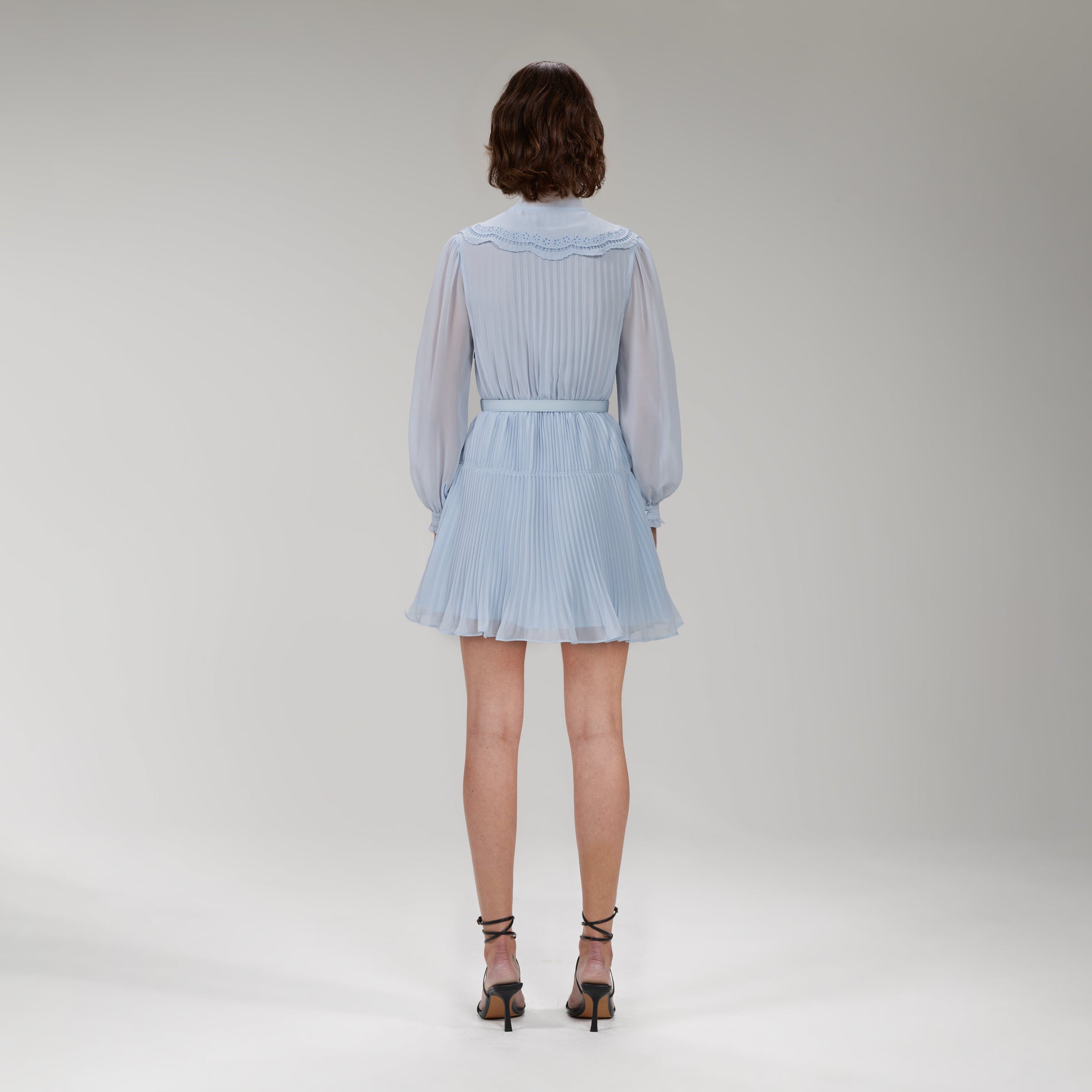 A woman wearing the Blue Broderie Collar Chiffon Mini Dress