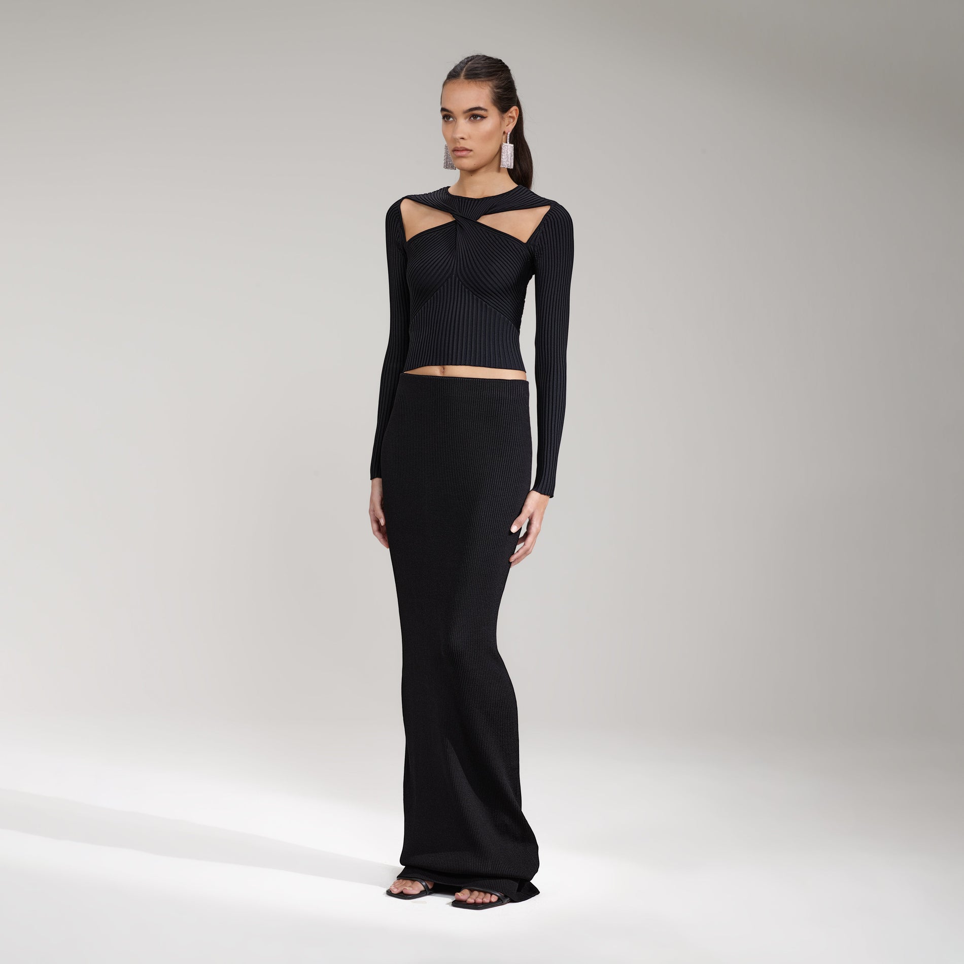 A woman wearing the Black Ribbed Knit Cut Out Top