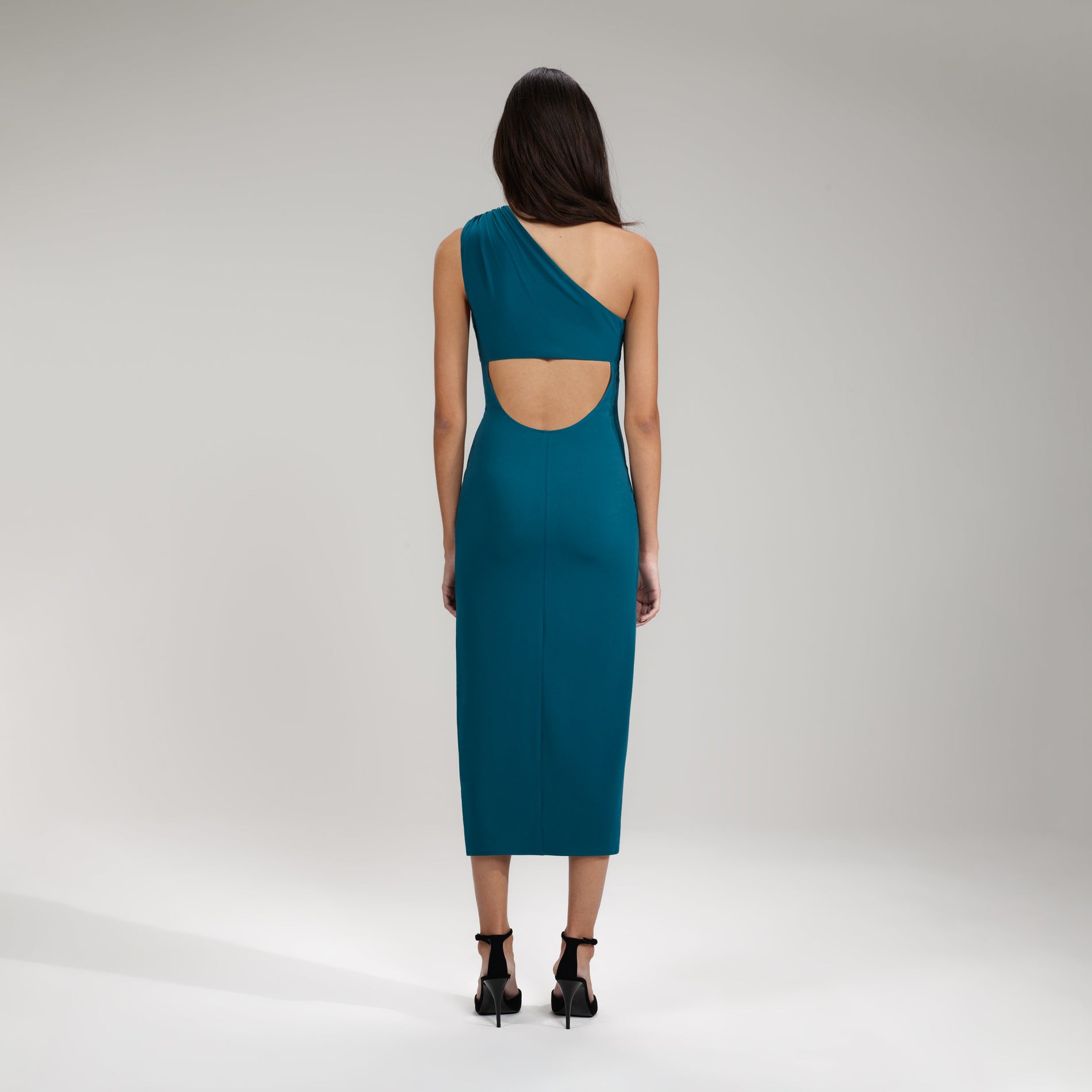 A woman wearing the Green Jersey One Shoulder Ruched Midi Dress