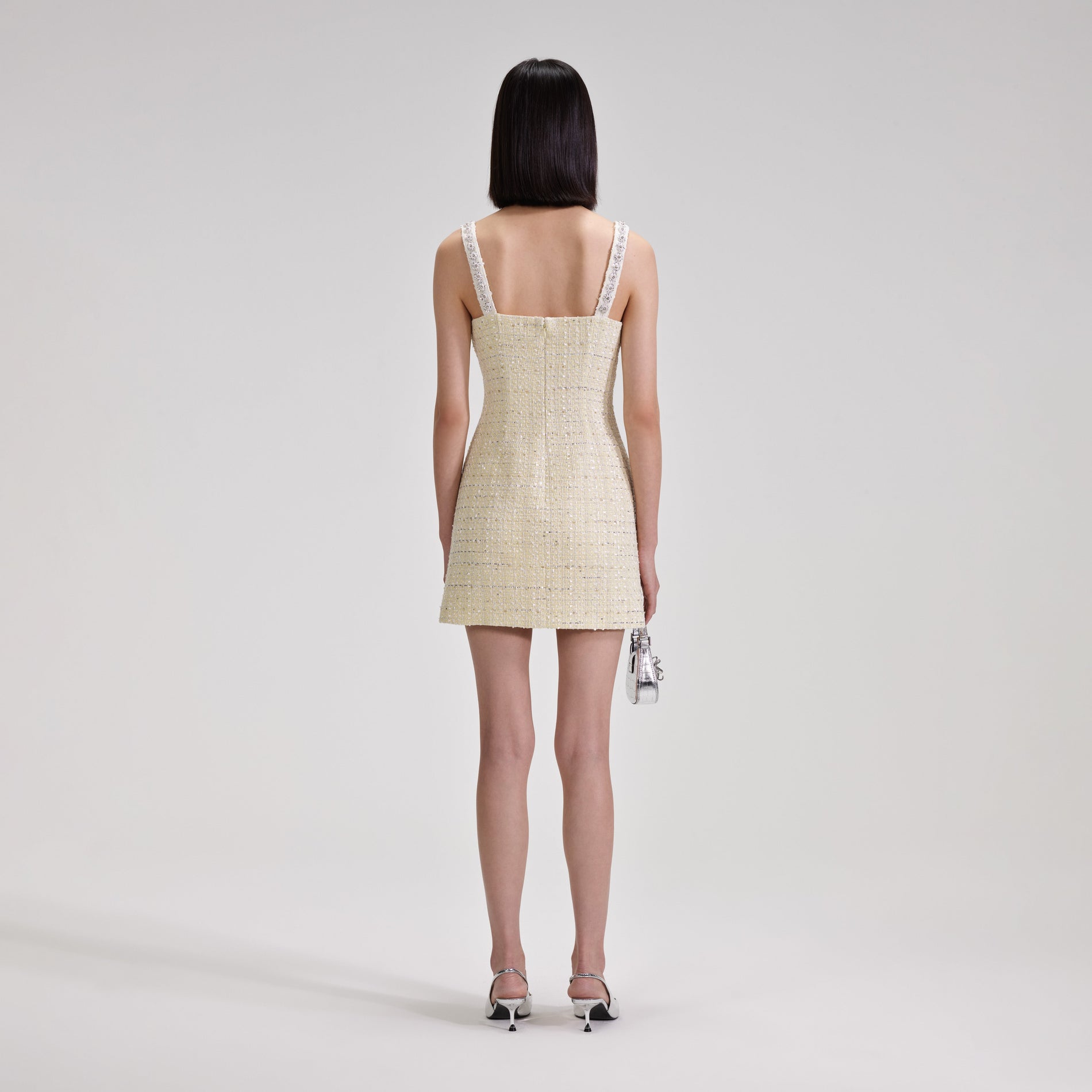 A woman wearing the Yellow Boucle Diamante Mini Dress