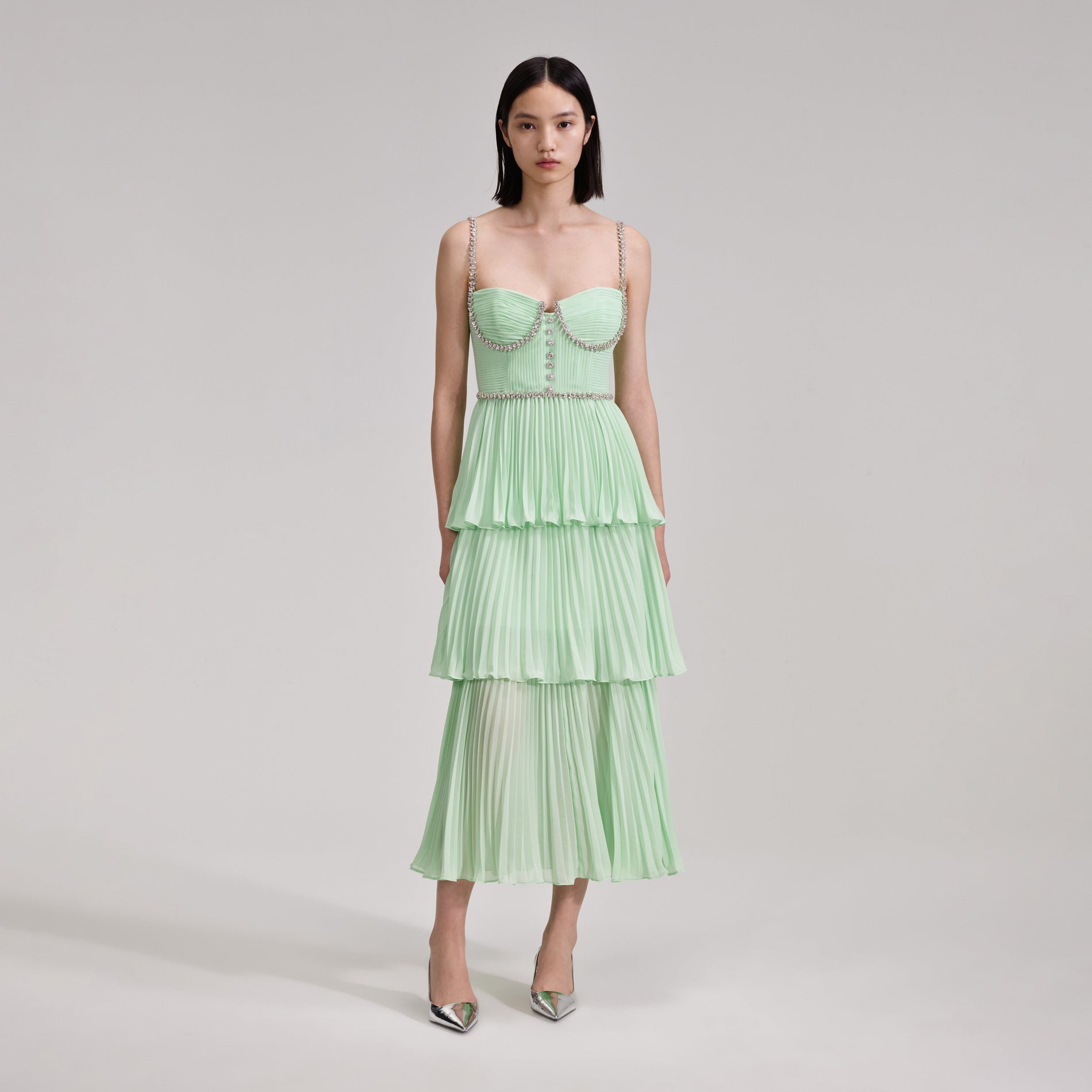 A woman wearing the Green Tiered Diamante Chiffon Midi Dress