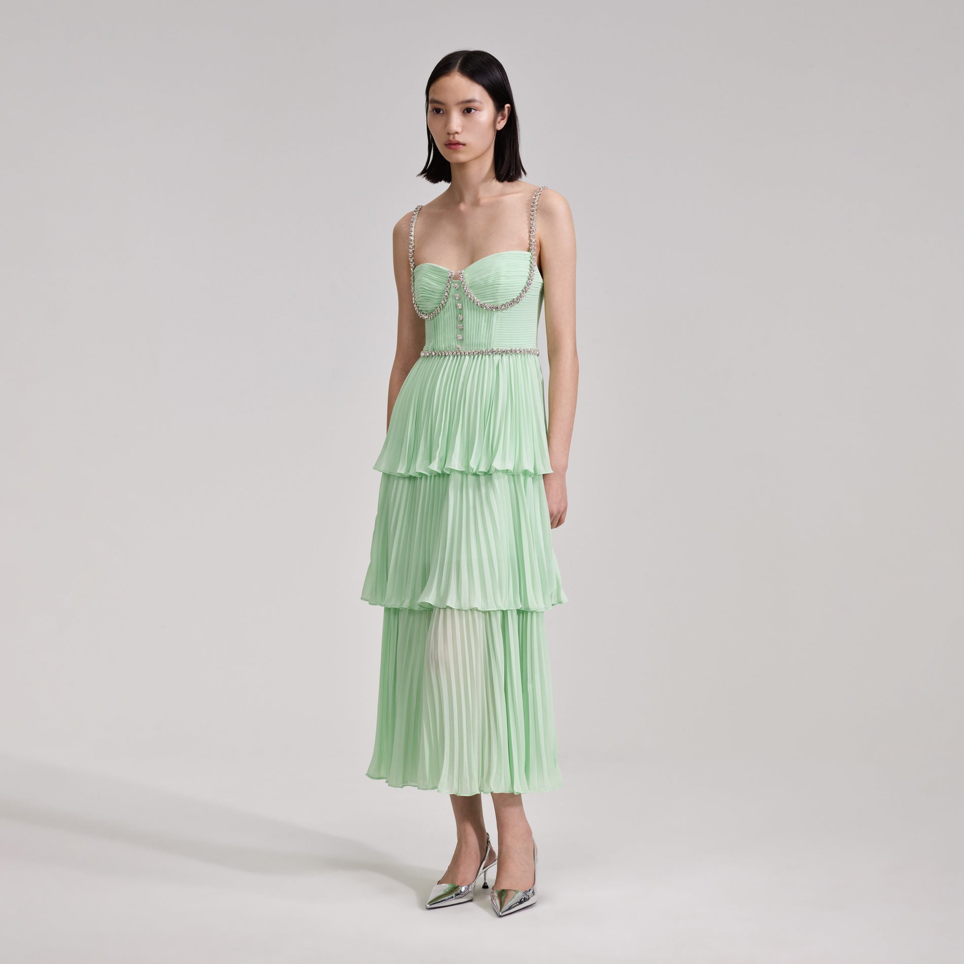A woman wearing the Green Tiered Diamante Chiffon Midi Dress
