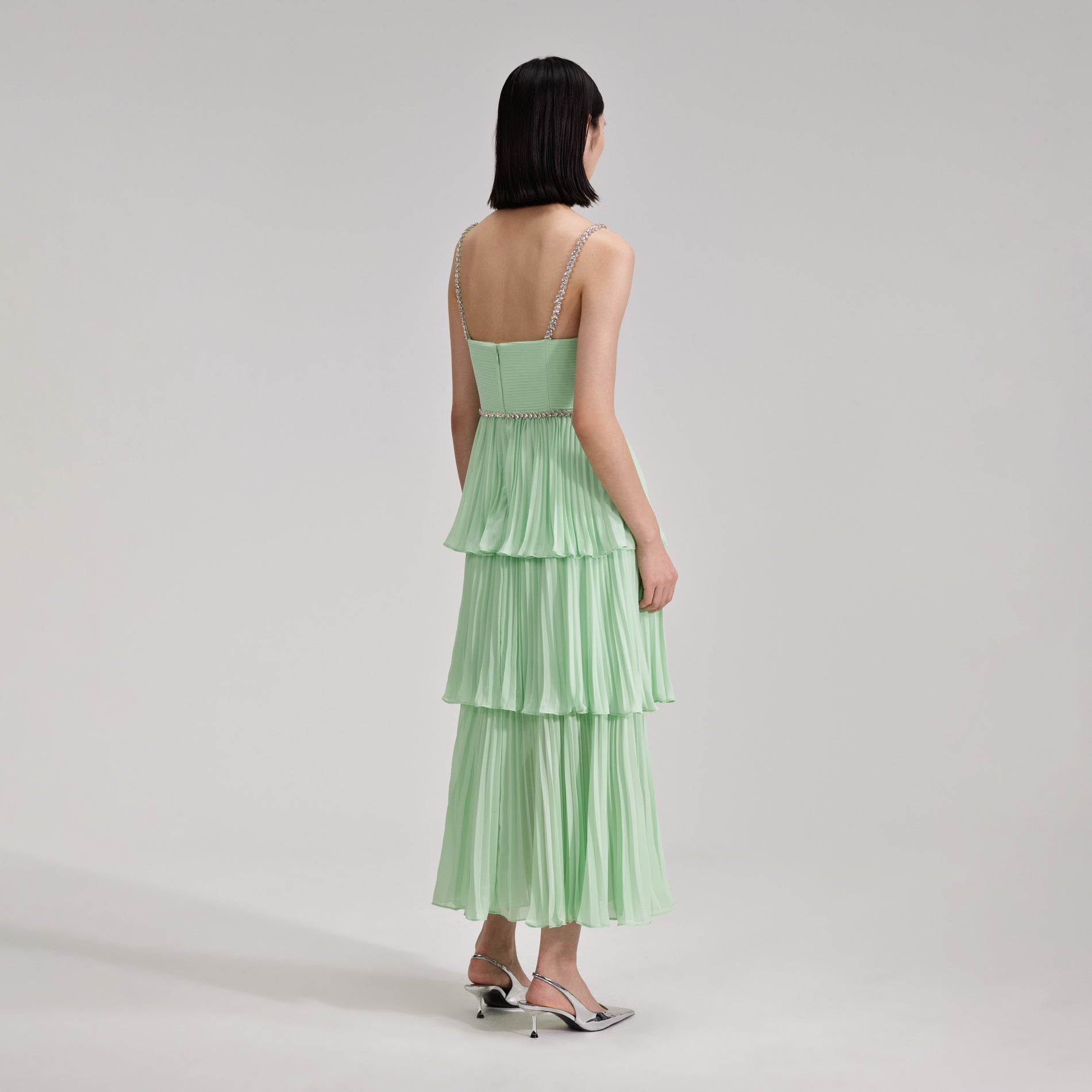 A woman wearing the Green Tiered Diamante Chiffon Midi Dress