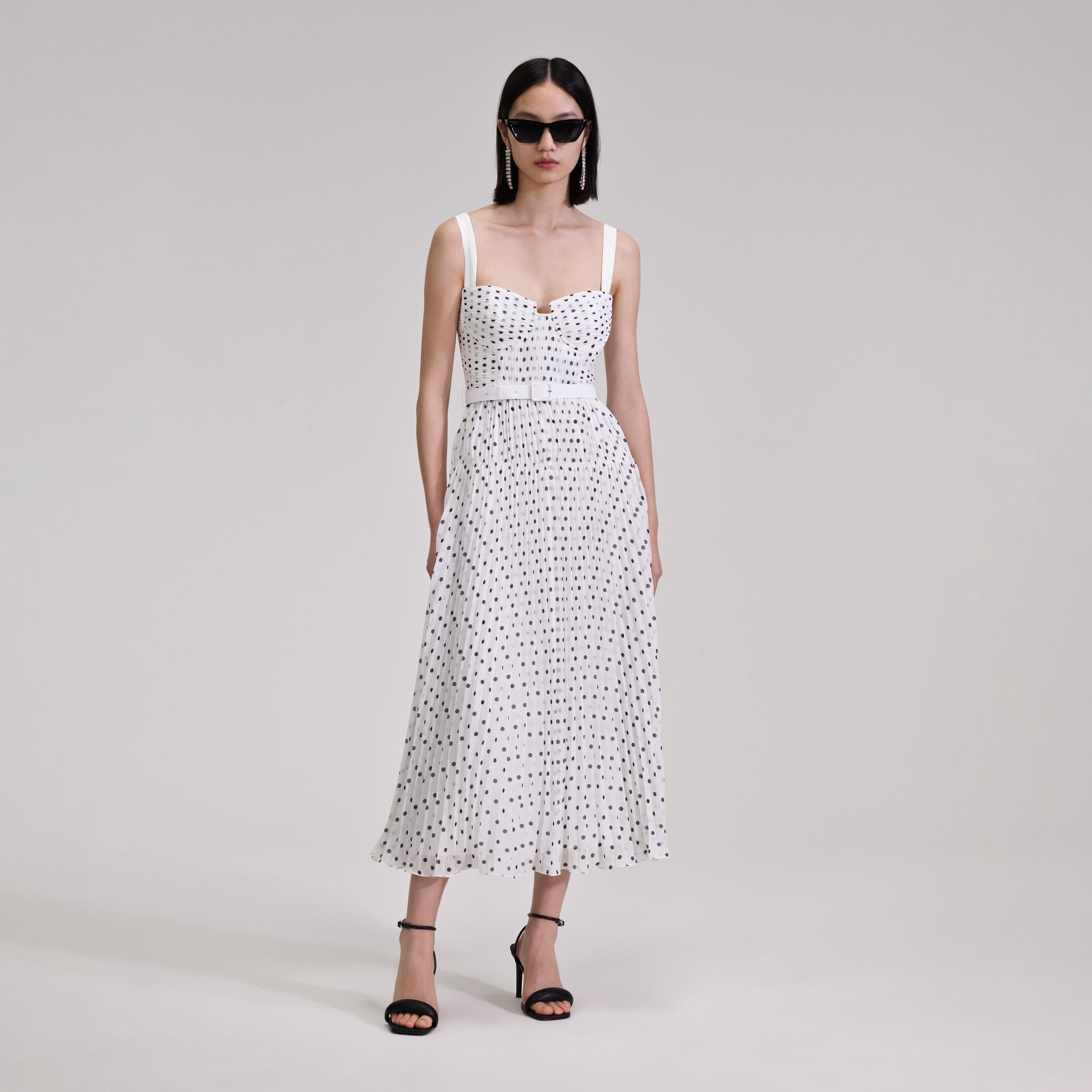 A woman wearing the Polka Dot Chiffon Midi Dress