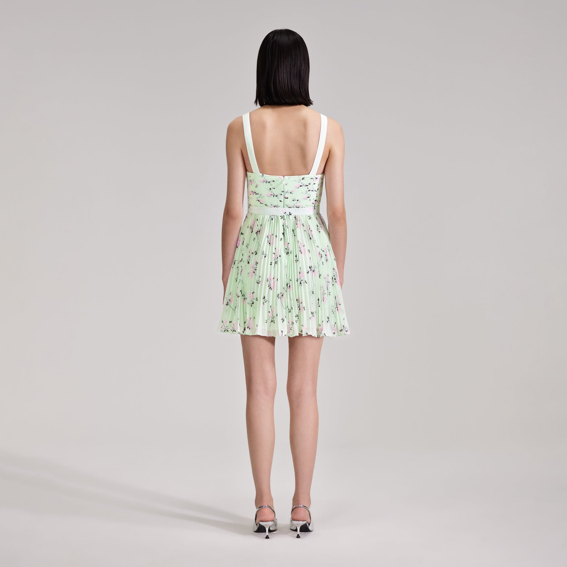 A woman wearing the Green Floral Print Mini Dress