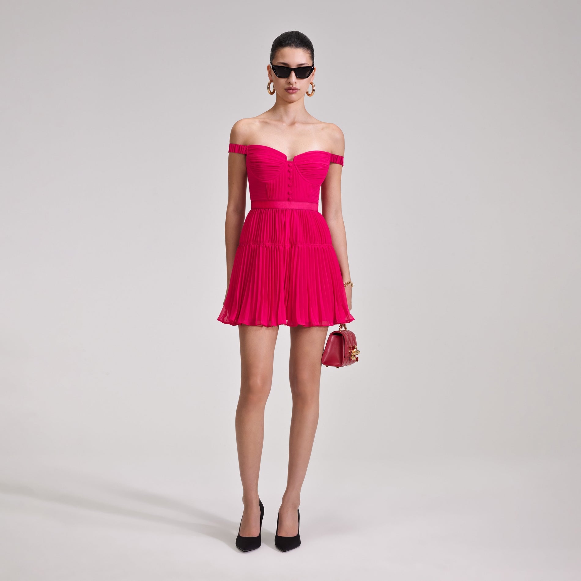 A woman wearing the Red Chiffon Off Shoulder Mini Dress