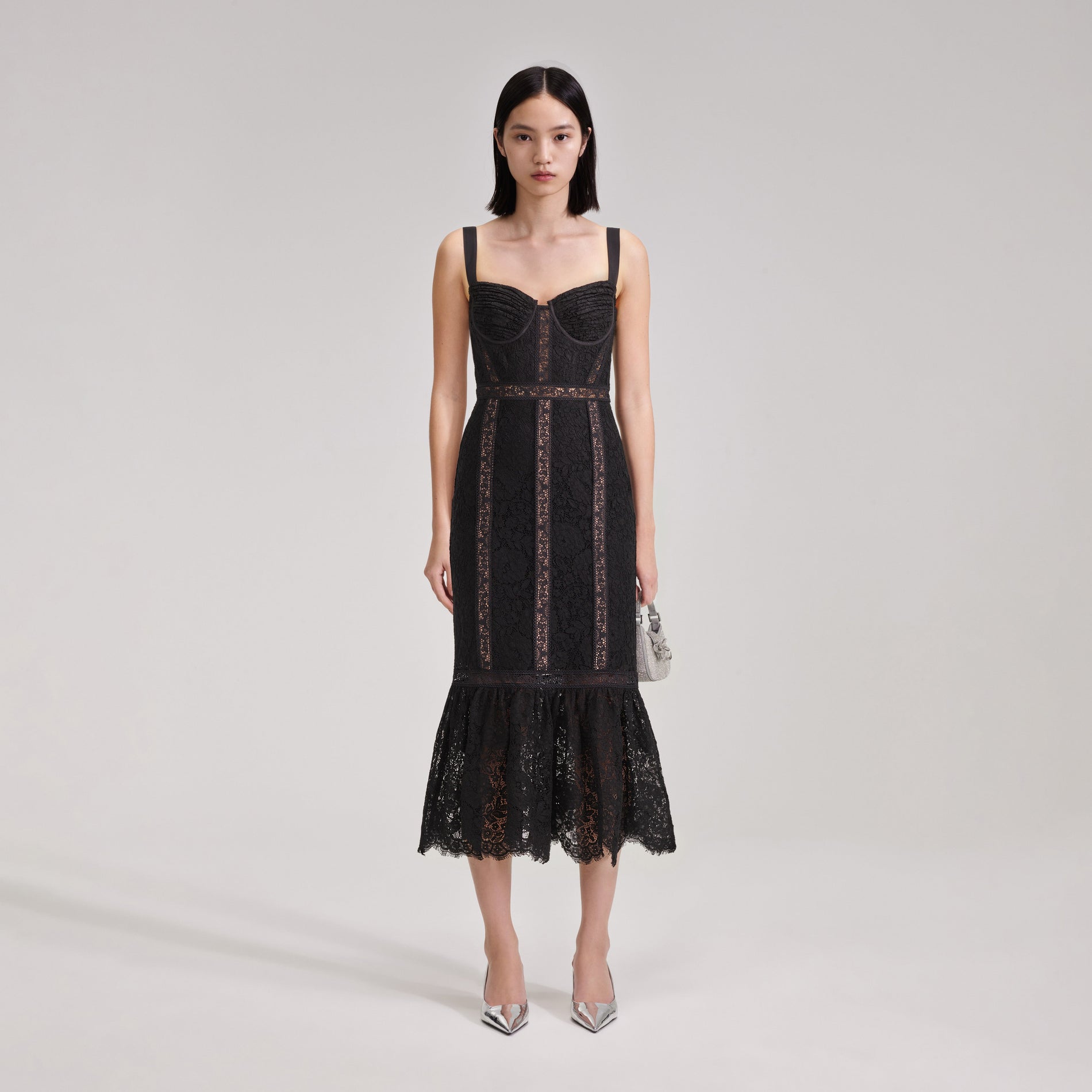 A woman wearing the Black Cord Lace Insert Midi Dress