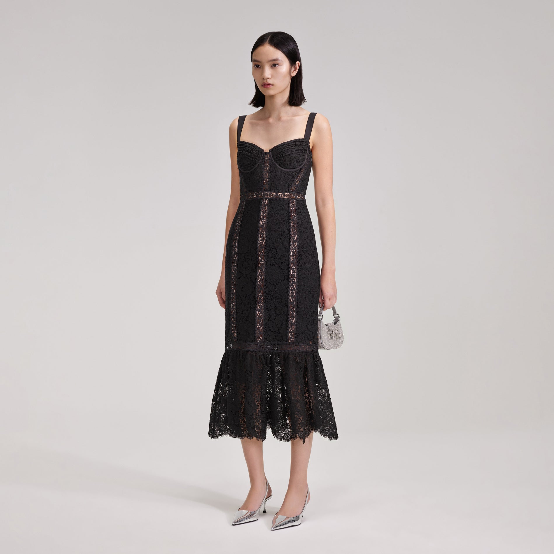 A woman wearing the Black Cord Lace Insert Midi Dress