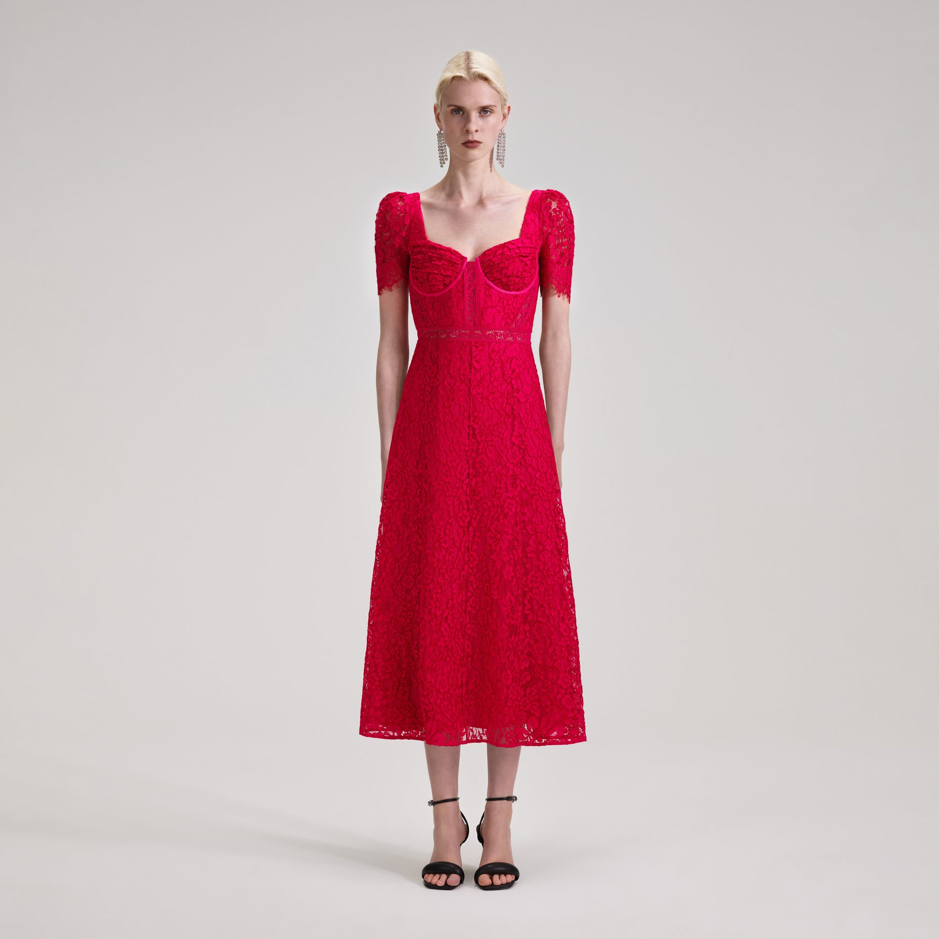 A woman wearing the Red Lace Midi Dress