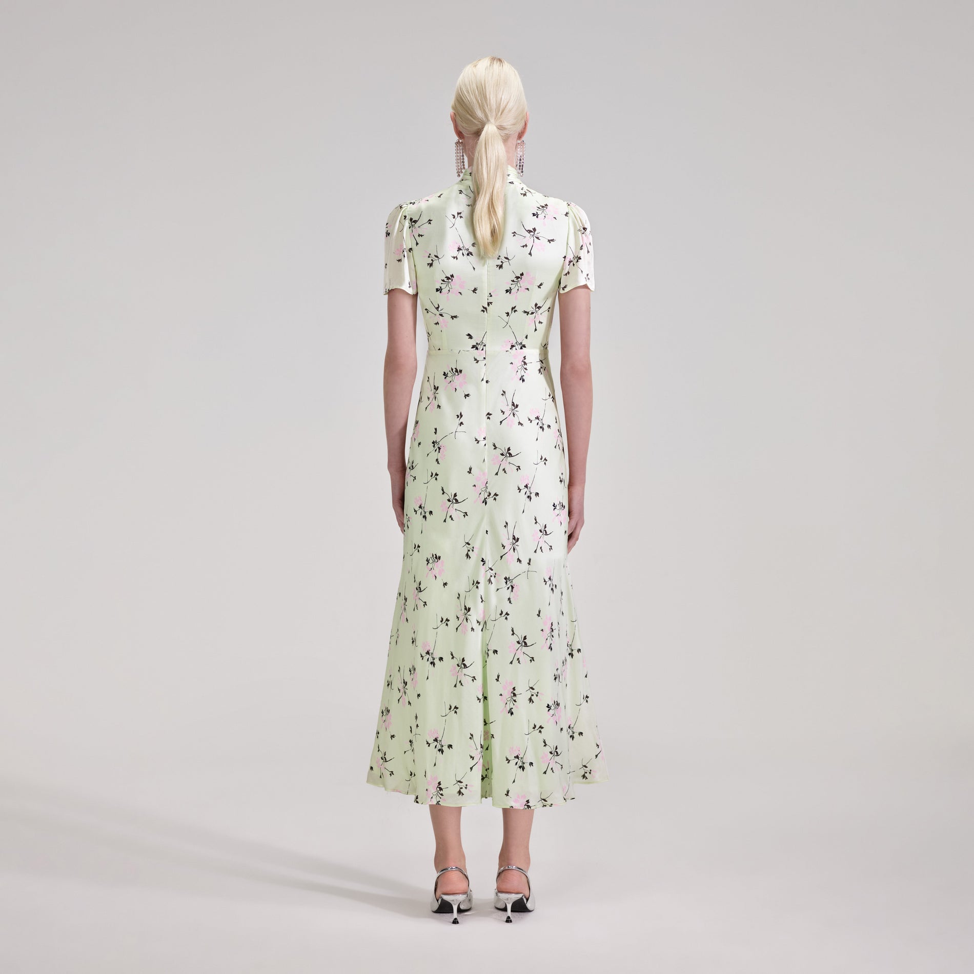 A woman wearing the Green Floral Print Midi Dress