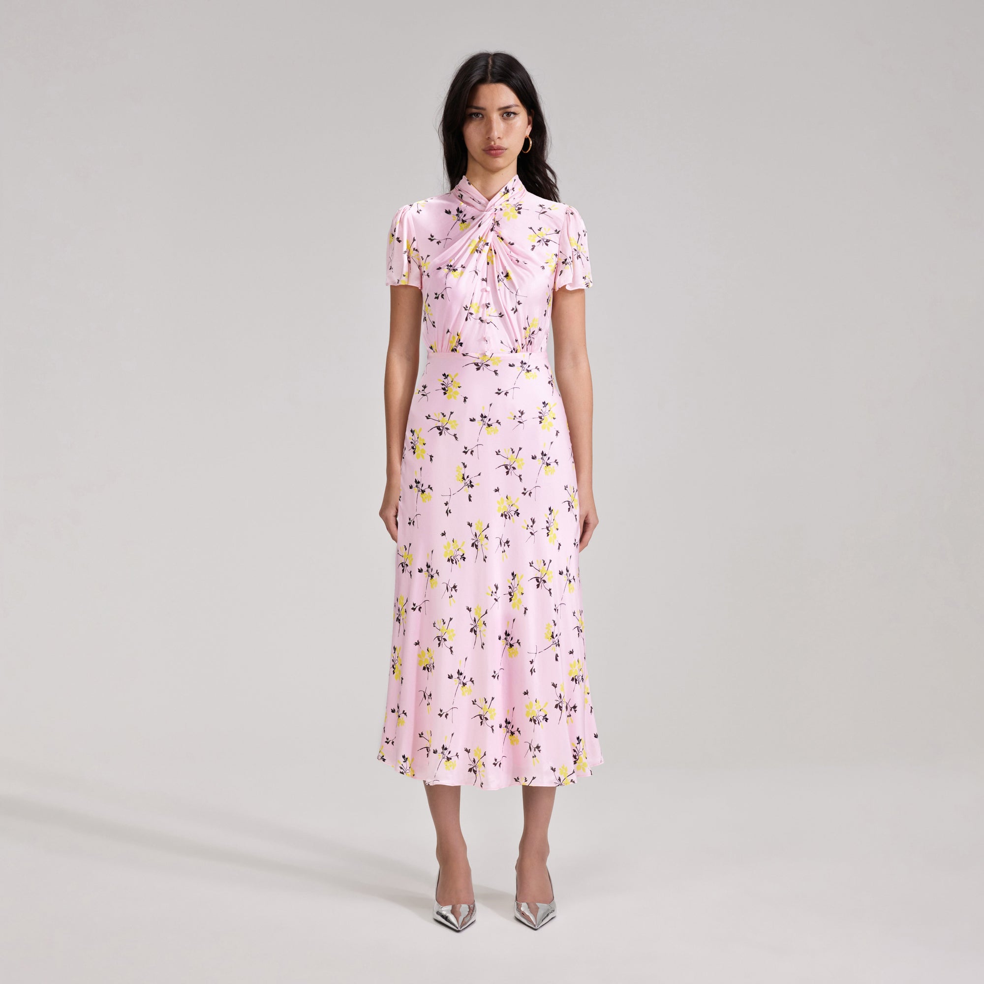 A woman wearing the Pink Floral Print Midi Dress