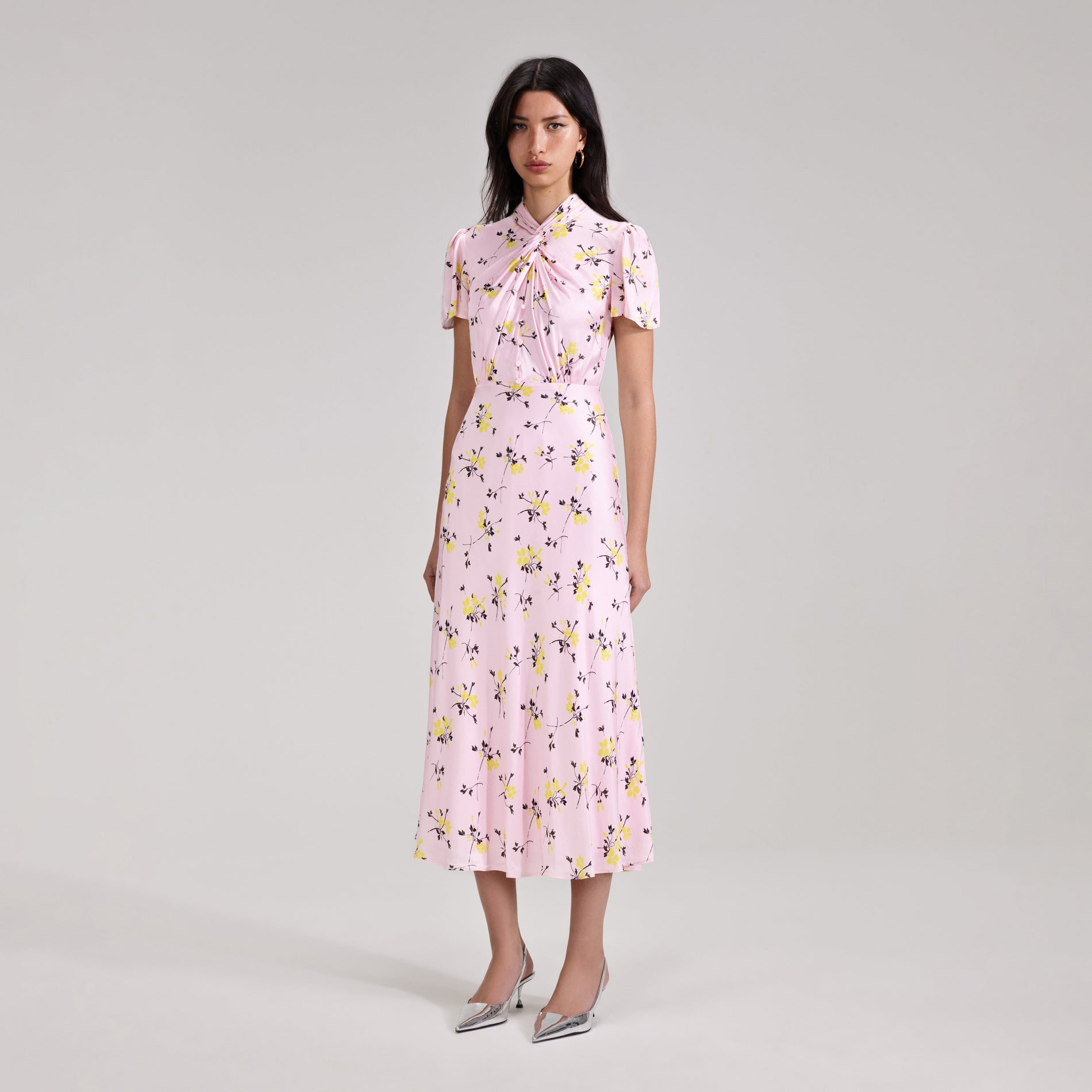 A woman wearing the Pink Floral Print Midi Dress