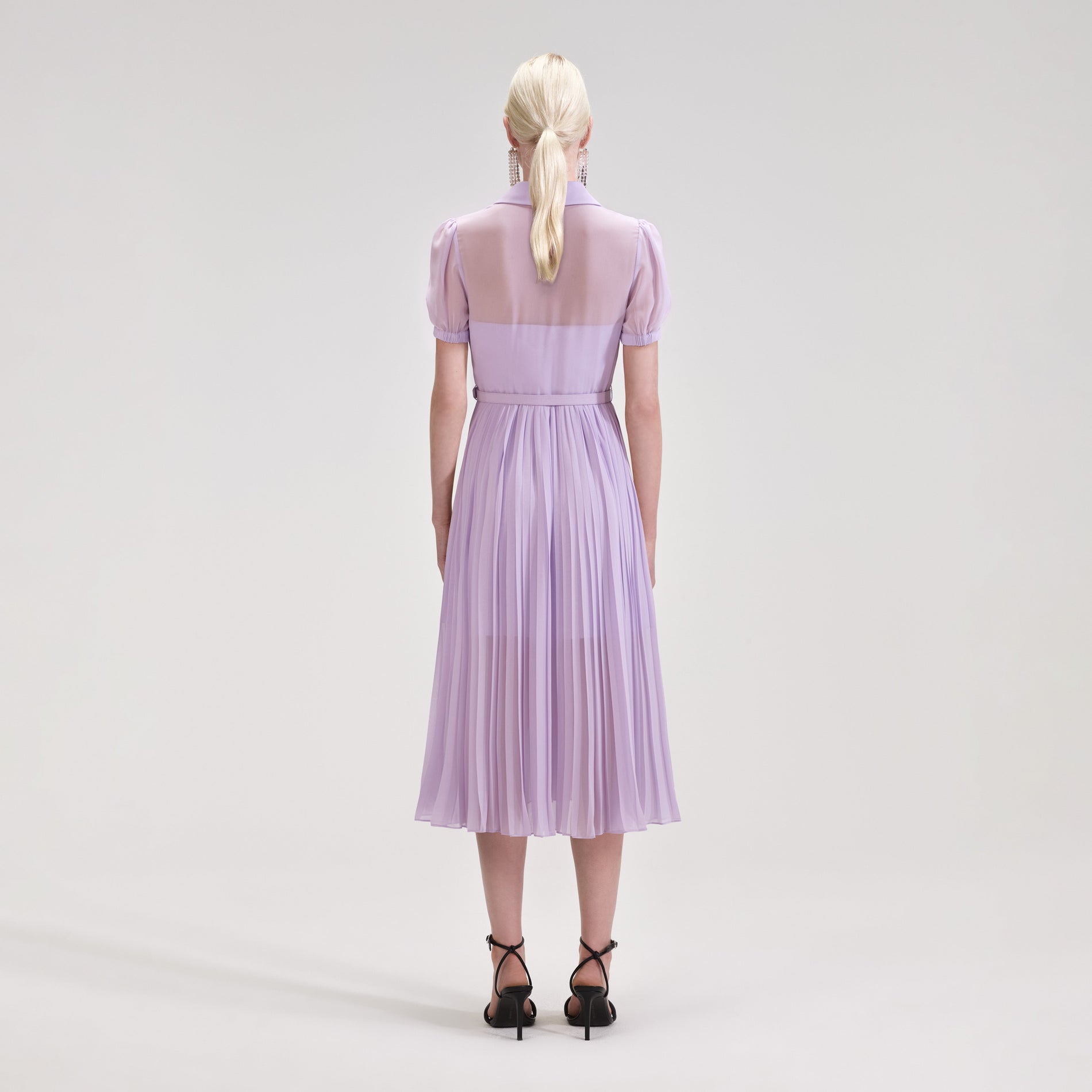 A woman wearing the Lilac Chiffon Pleated Collar Midi Dress