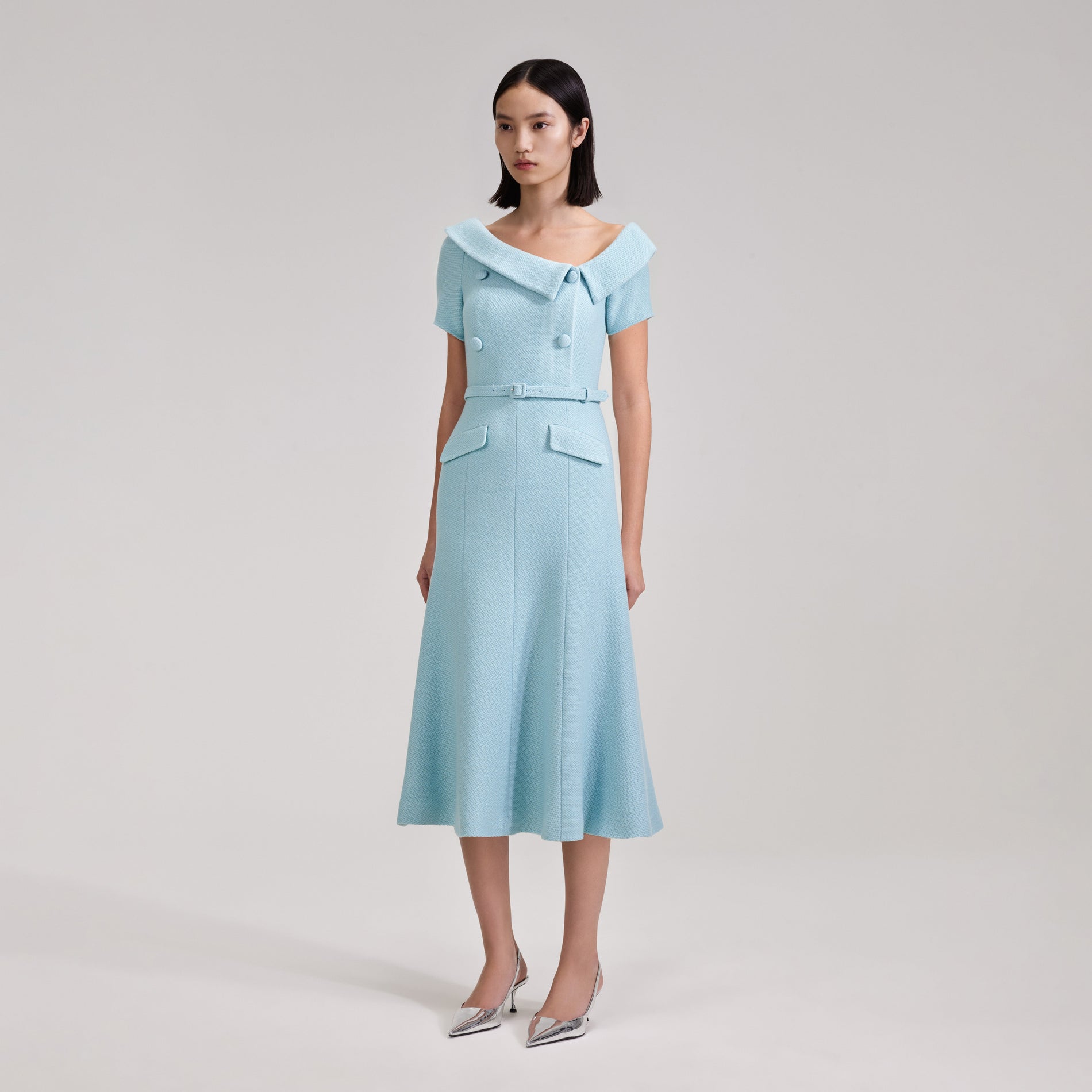 A woman wearing the Blue Textured Woven Midi Dress