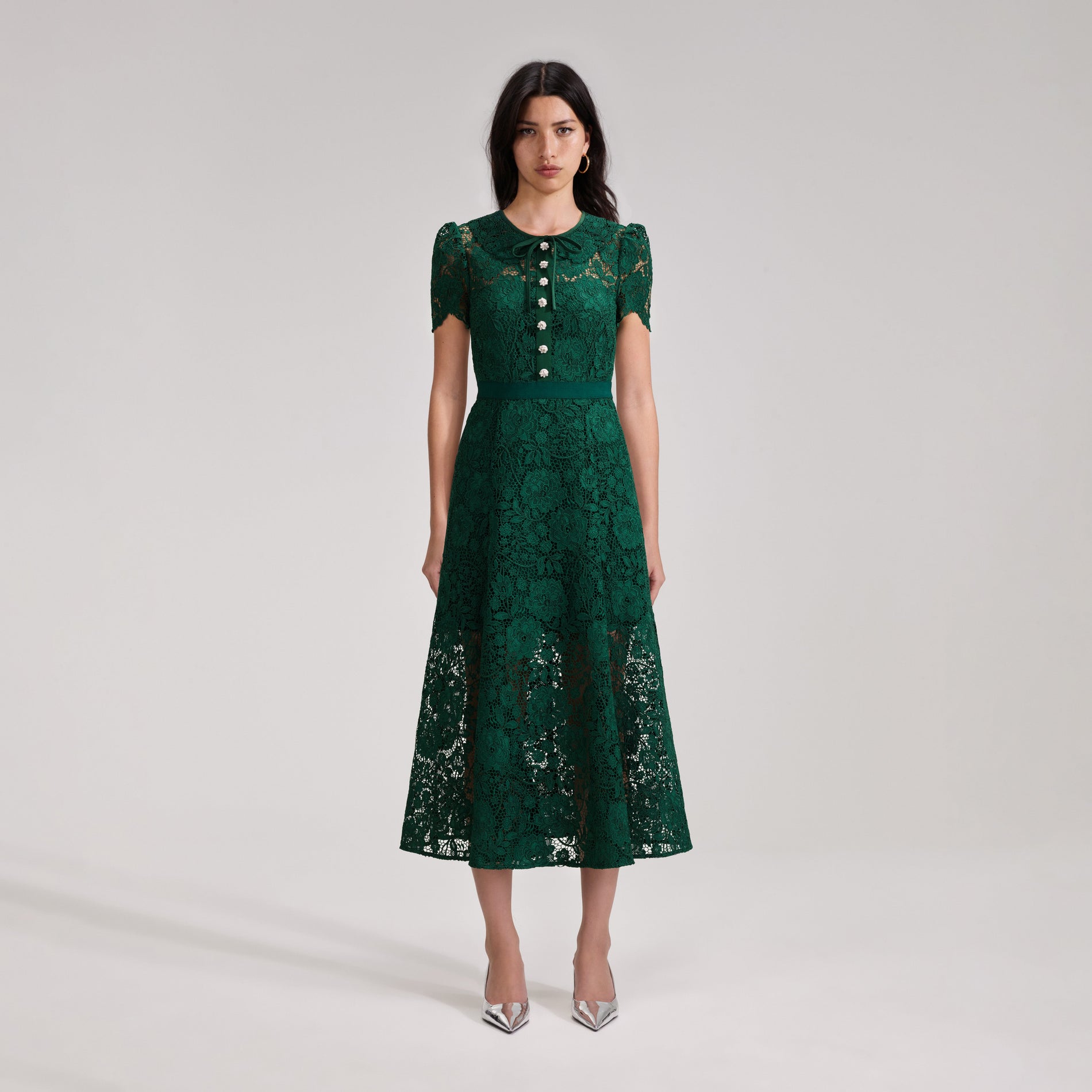 A woman wearing the Green Cord Lace Midi Dress